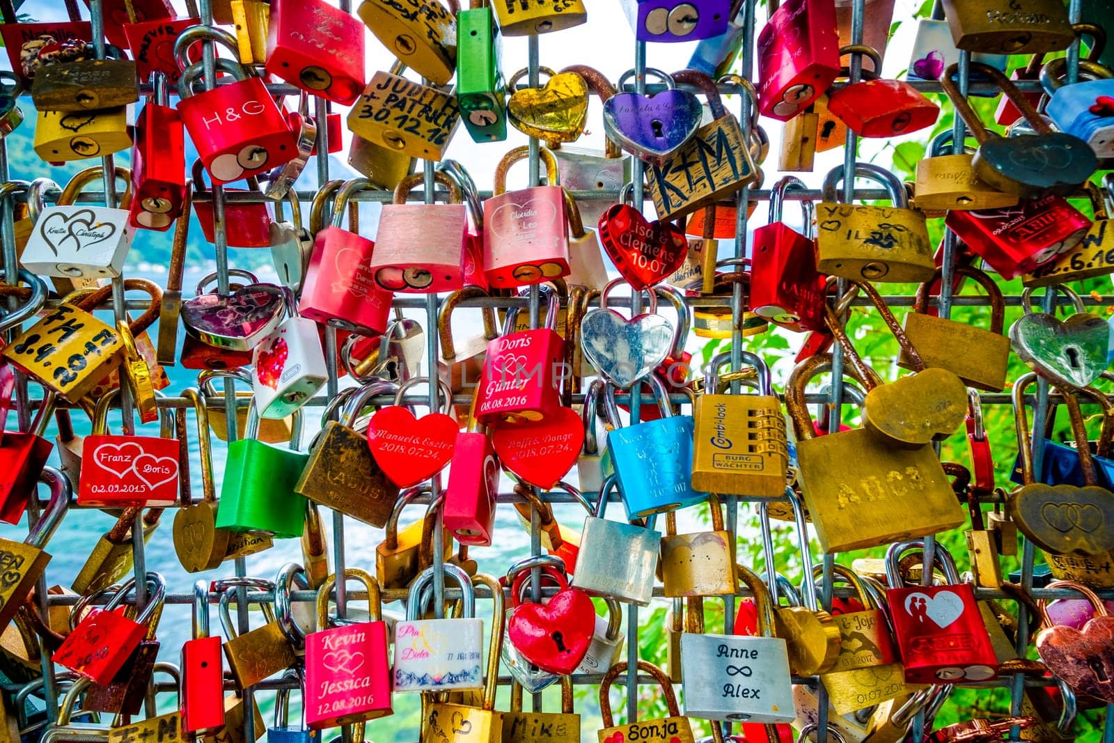 Hallstatt, Austria - 22 September 2018: A lot of colorful different shaped love locks on the fence