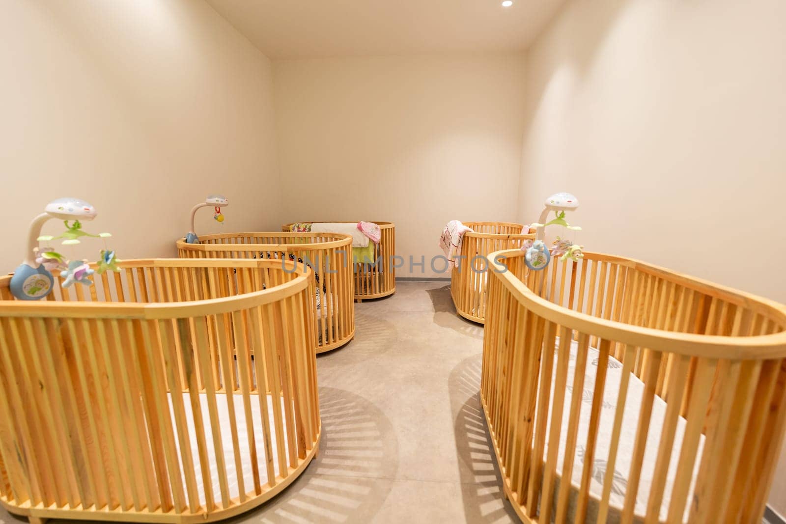 Modern nursery room with wooden baby cribs and soothing decor for infants comfort