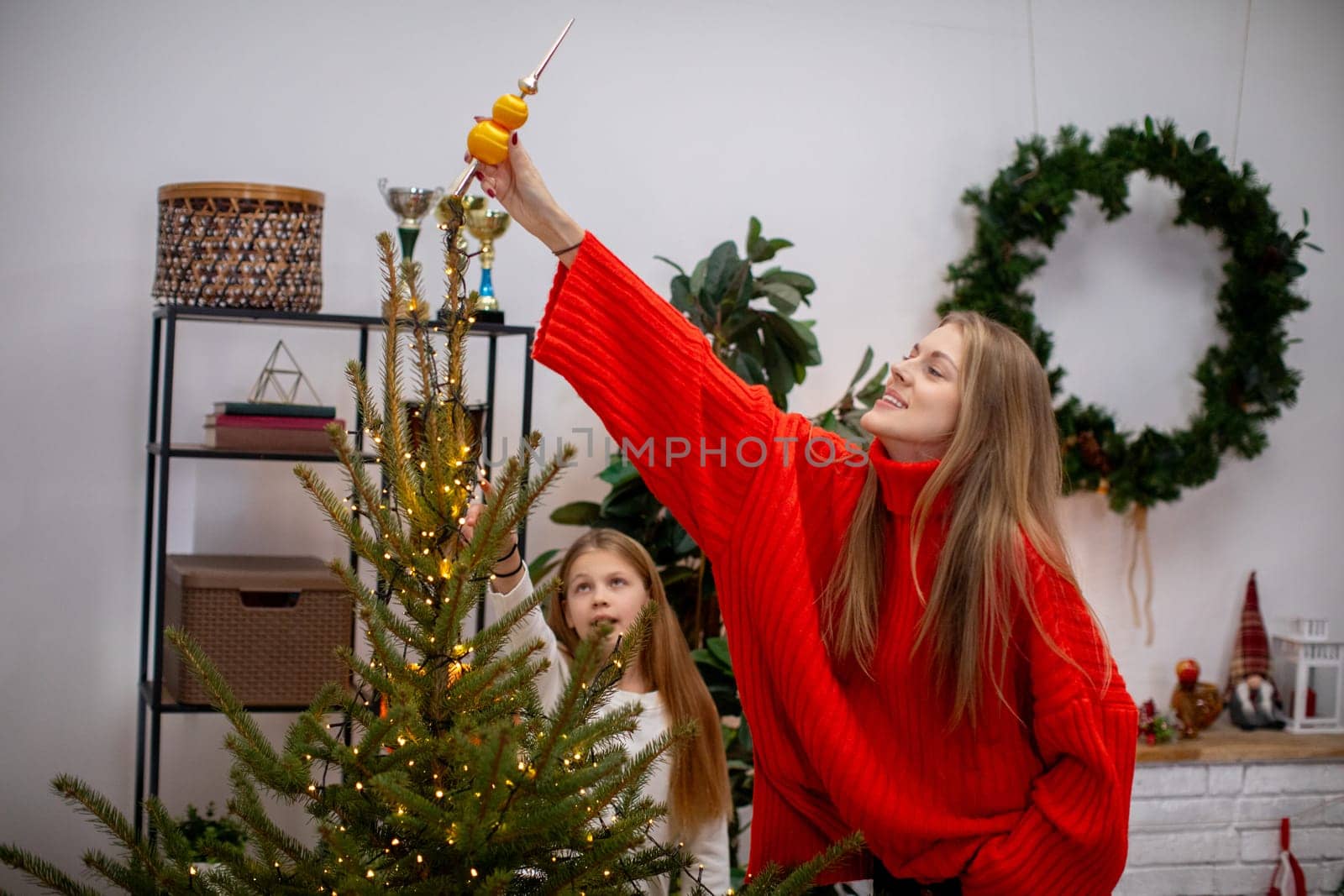 A joyful family decorates a beautiful Christmas tree, capturing the holiday spirit and togetherness