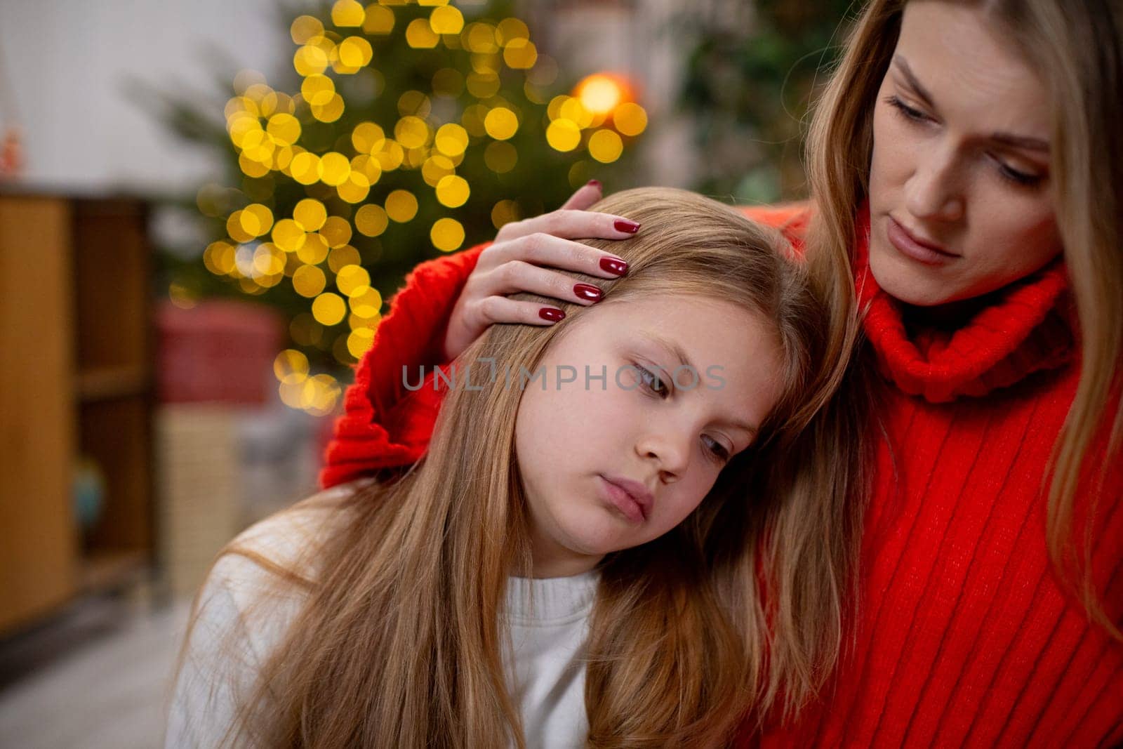 A mother brings deep comfort to her daughter during the festive season, capturing a heartfelt moment