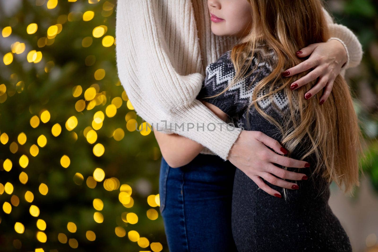 A truly heartfelt moment of deep affection shared in front of beautiful twinkling holiday lights all around