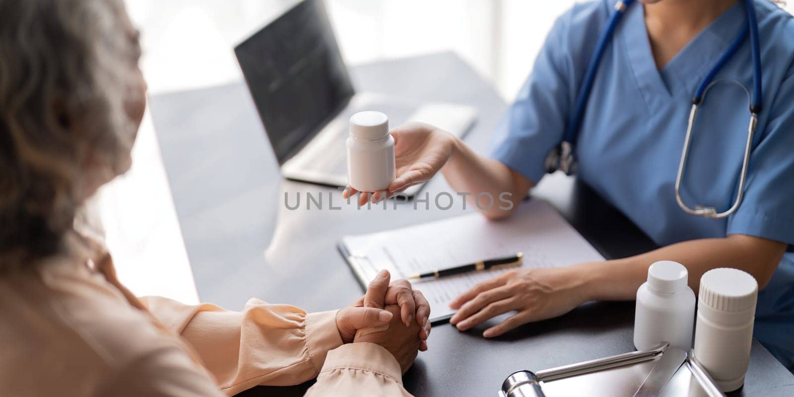 Doctor or physician recommend pill medical prescription to elderly female patient.