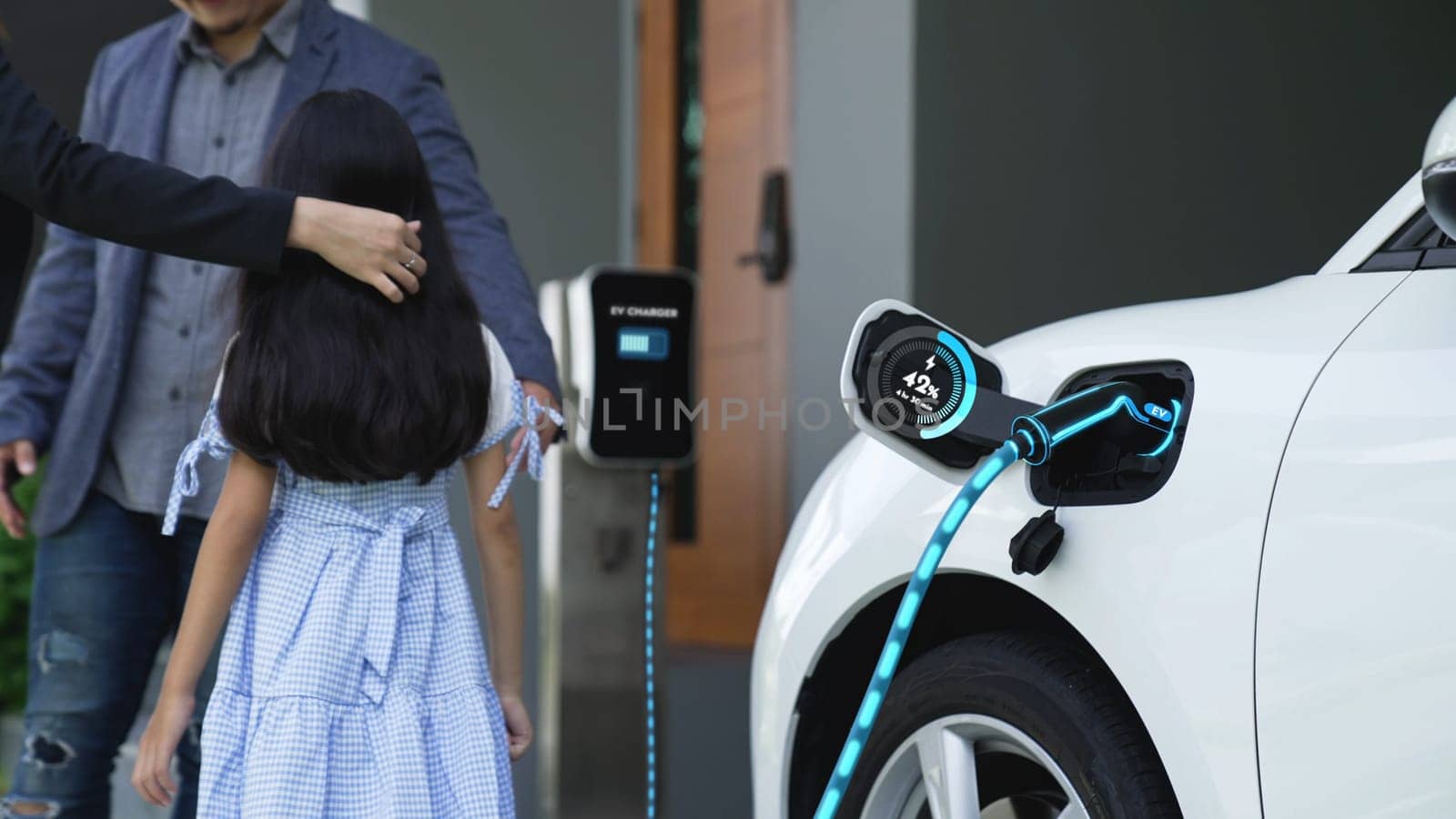 Modern family recharge electric car from home charging station. Peruse by biancoblue