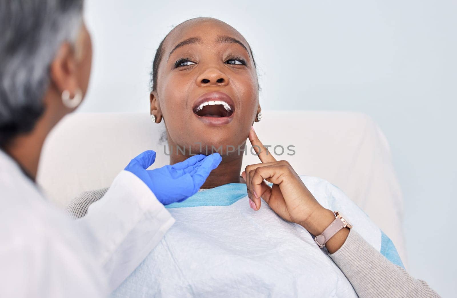 Dentist, patient and women at clinic, toothache with consultation and check mouth for dental and medical treatment. Oral hygiene, healthcare and orthodontics, tooth decay with cleaning for cavity.