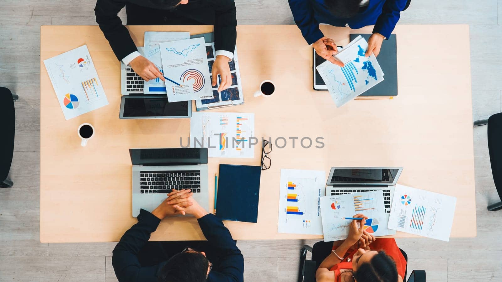 Business people group meeting shot from top view in office . Profession businesswomen, businessmen and office workers working in team conference with project planning document on meeting table . Jivy