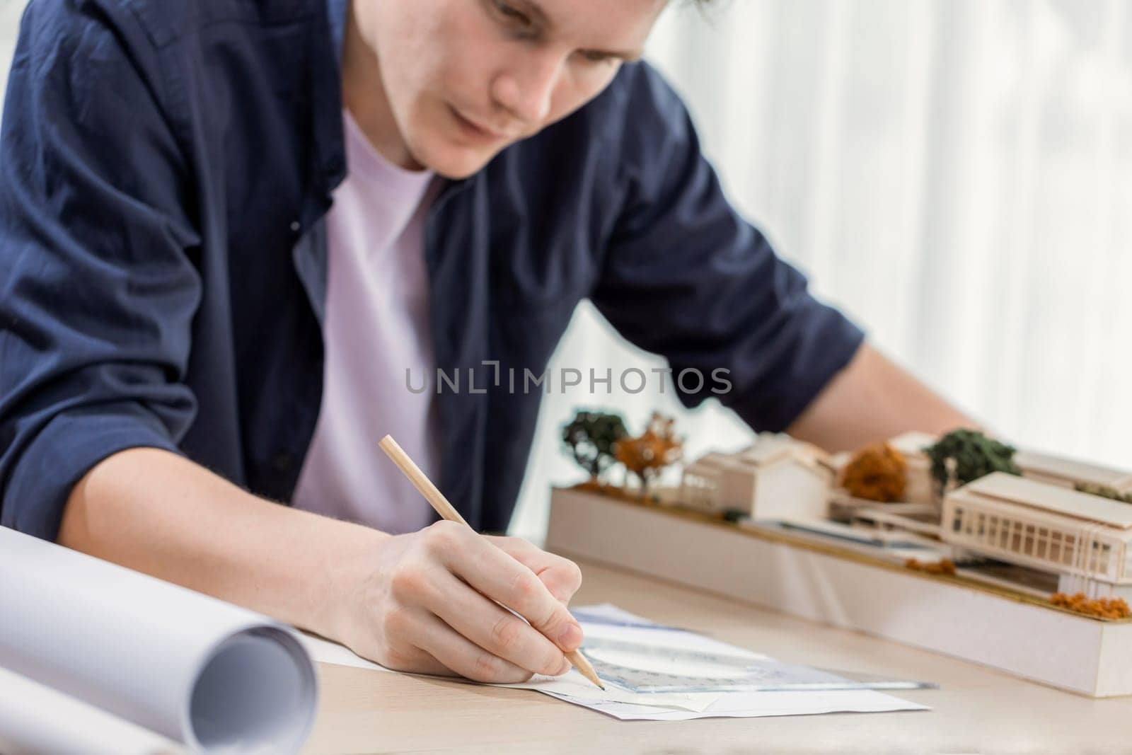 Drafting interior house design by architect designer planning home layout on blueprint paper on office desk. Architect carefully drawing home interior layout with pencil and tool. Iteration