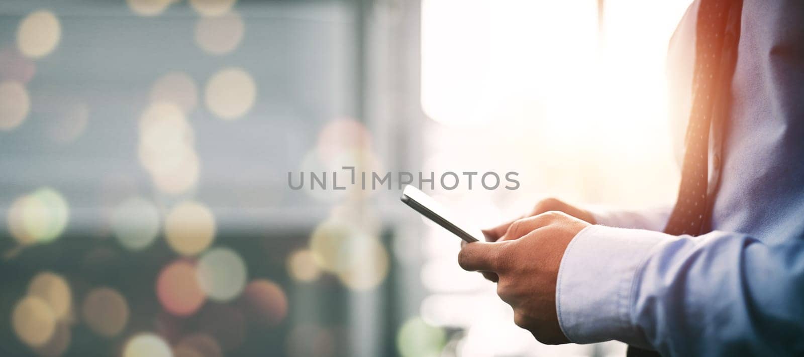 Man, cellphone and texting with hands, bokeh and networking for corporate, business and employee. App, communication and reading news while networking, web browsing and digital strategy search by YuriArcurs