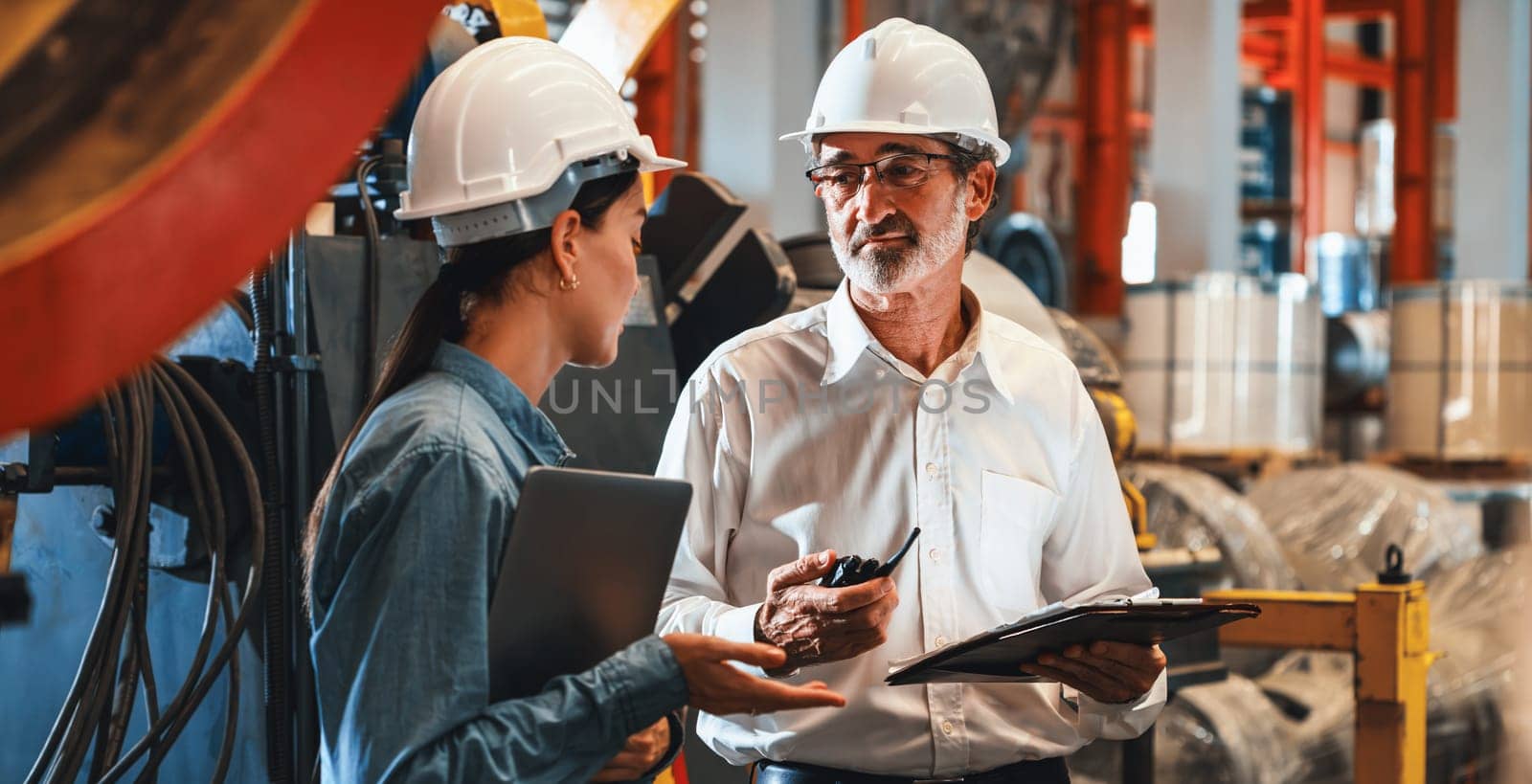 Metalwork manufacturing factory engineer manager conduct inspection of steel industrial machine, exemplifying leadership as machinery engineering inspection supervisor in the facility. Panorama