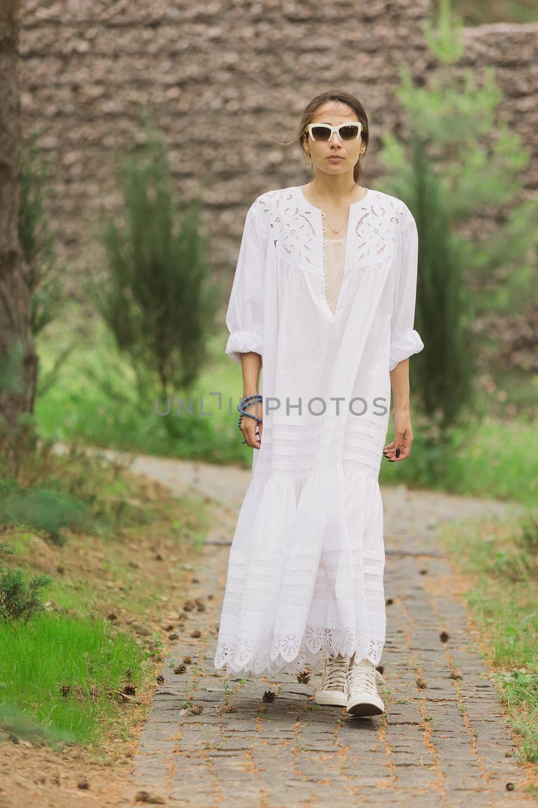 beautiful young woman in elegant dress outdoors.