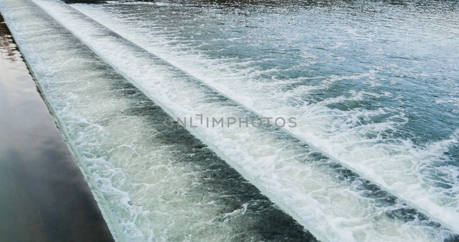 Cascade waterfall river. View of water cascades on the dam.