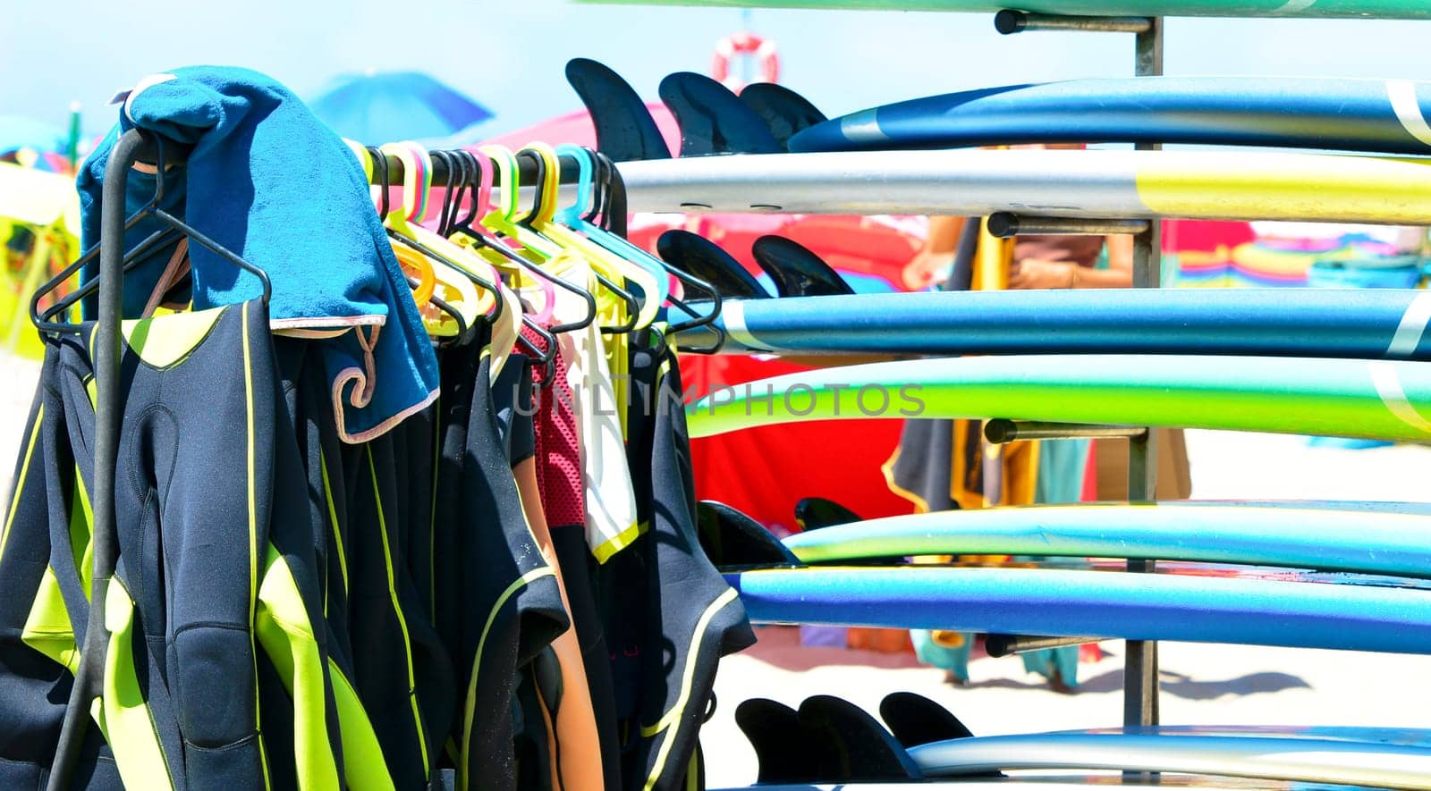 Surfboards and uniforms on the beach of Atlantic ocean at the surf school