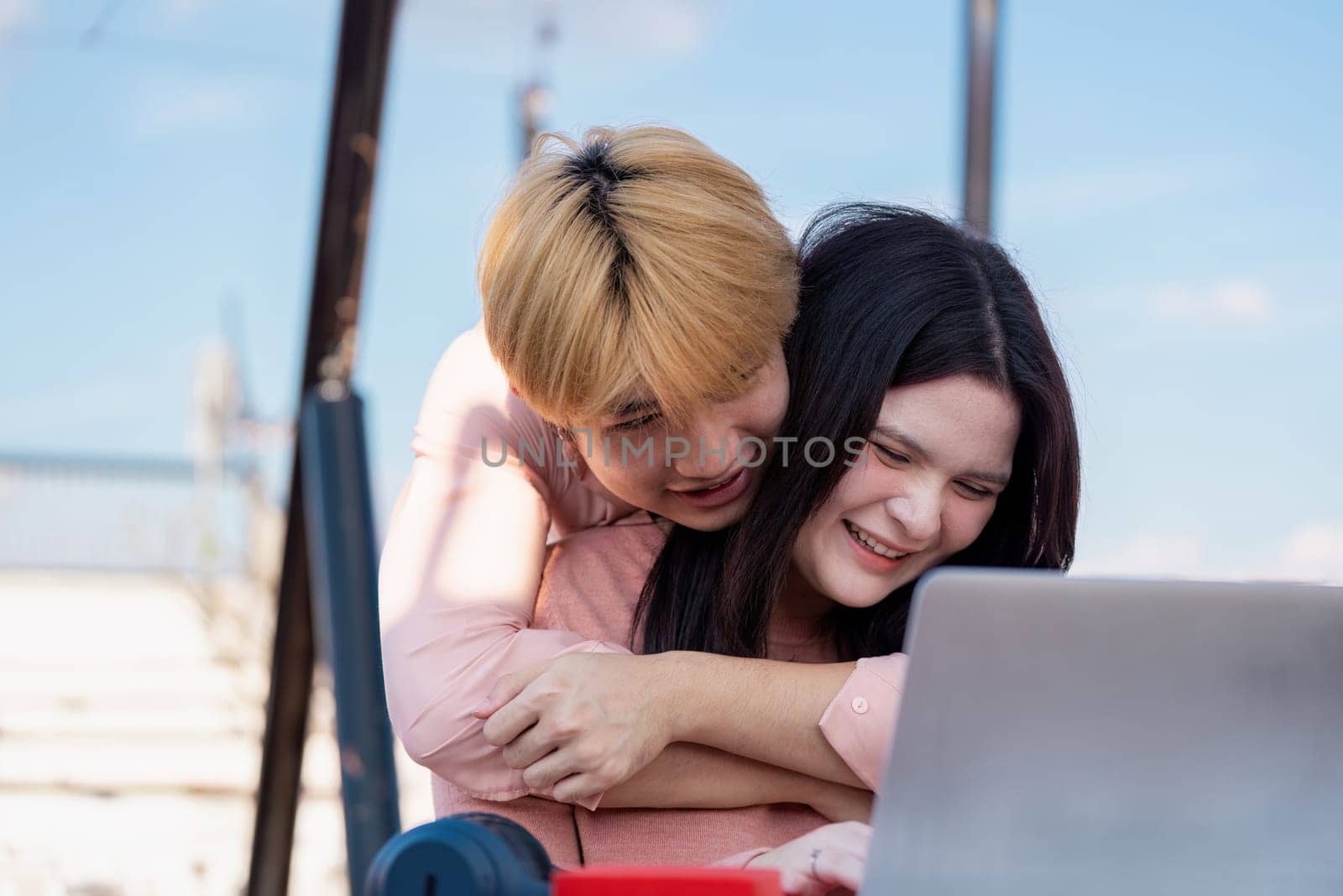 A couple shares a joyful moment together while celebrating Valentine Day enjoying their time in a cozy indoor setting.