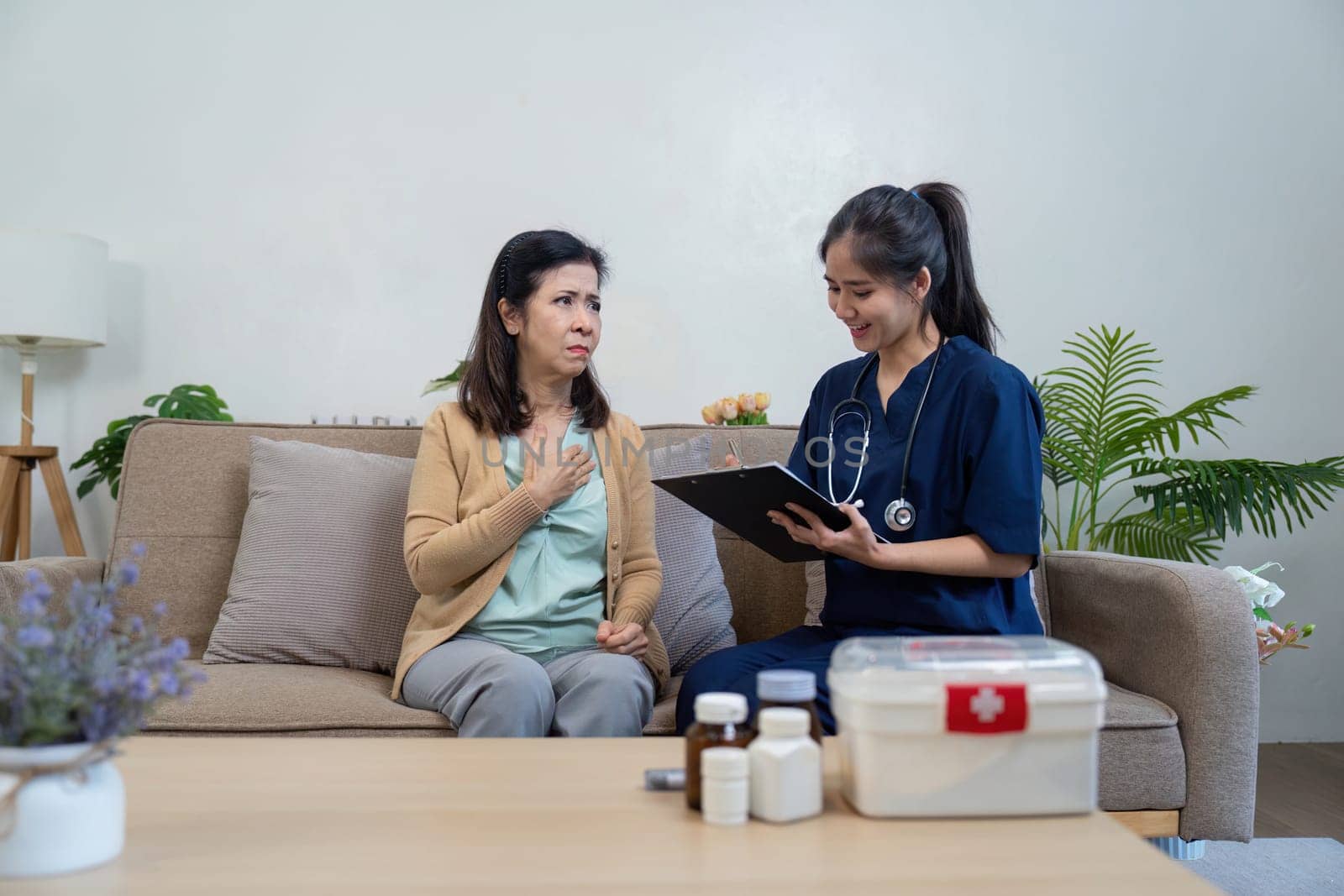 A caregiver provides a health assessment for an elderly patient in a cozy home setting ensuring compassionate support.