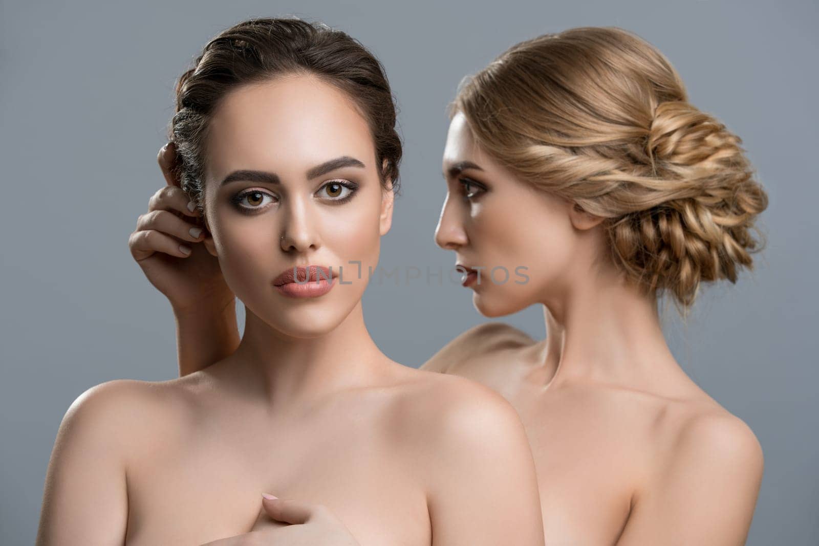 Two gorgeous women with fine makeup and hairstyles topless portrait