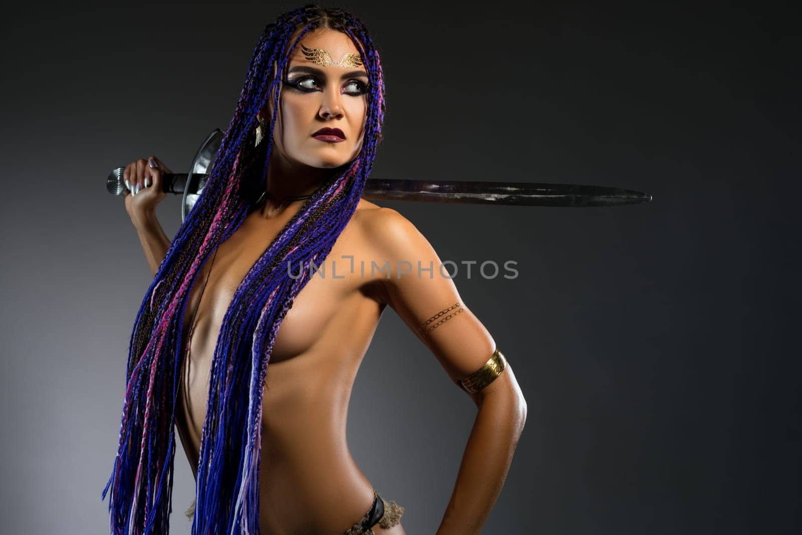 Amazon topless with blue braids with a sword portrait