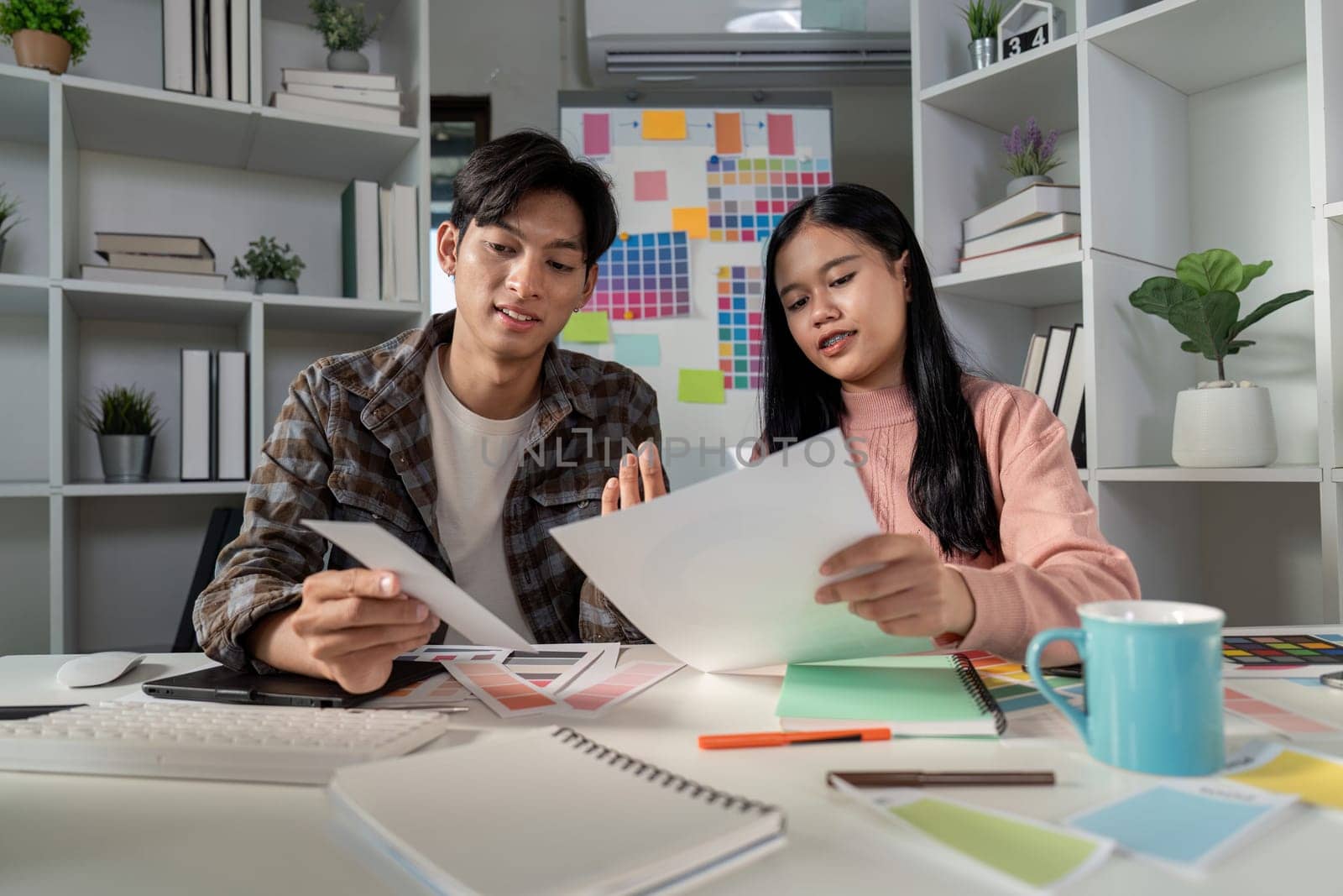 A team collaborates on graphic design projects fostering creativity and innovation in a modern office environment.
