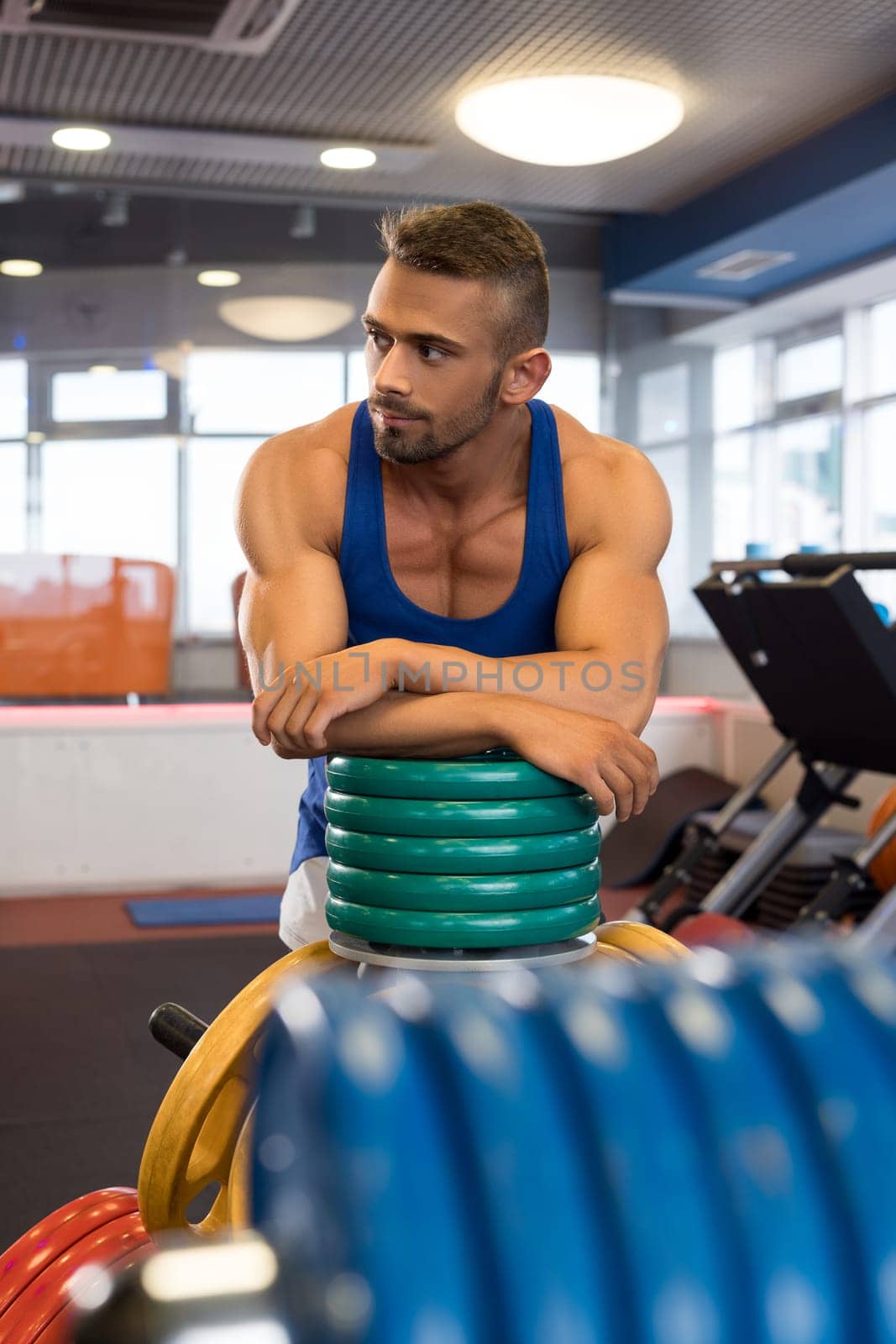 Young sporty male exercising in a gym portrait