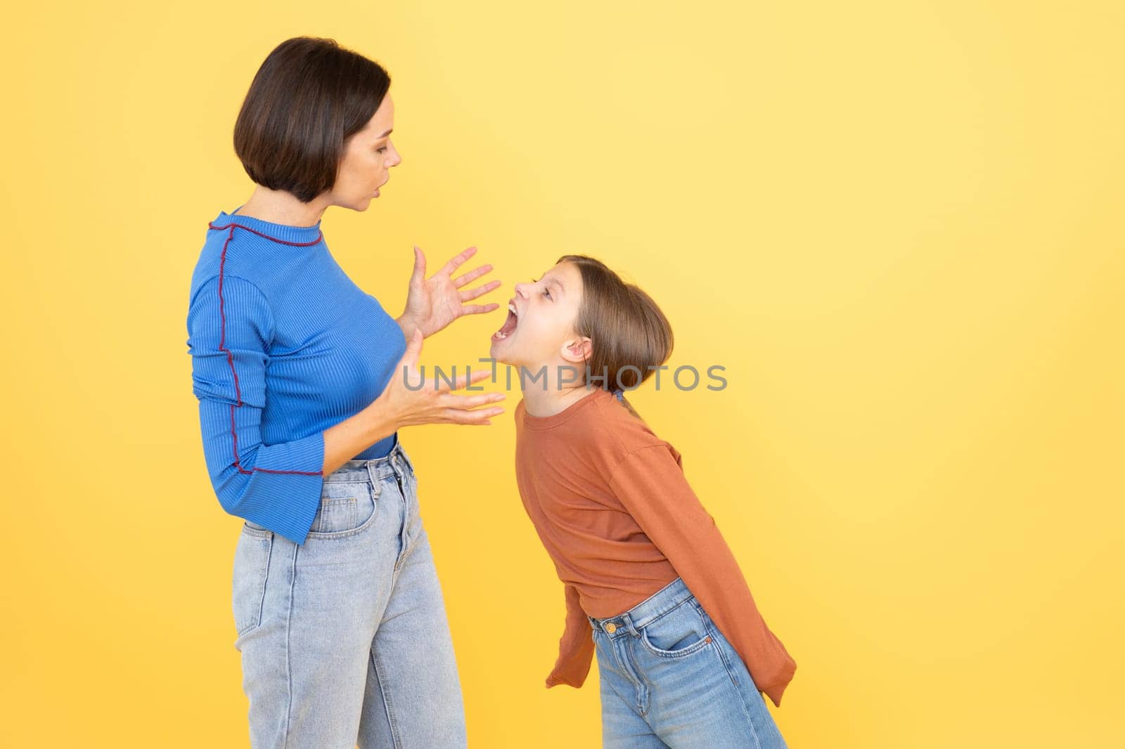 A woman and her preteen daughter engage in an animated conversation, both showing expressions of affection and playfulness. They are positioned against a bright yellow background.