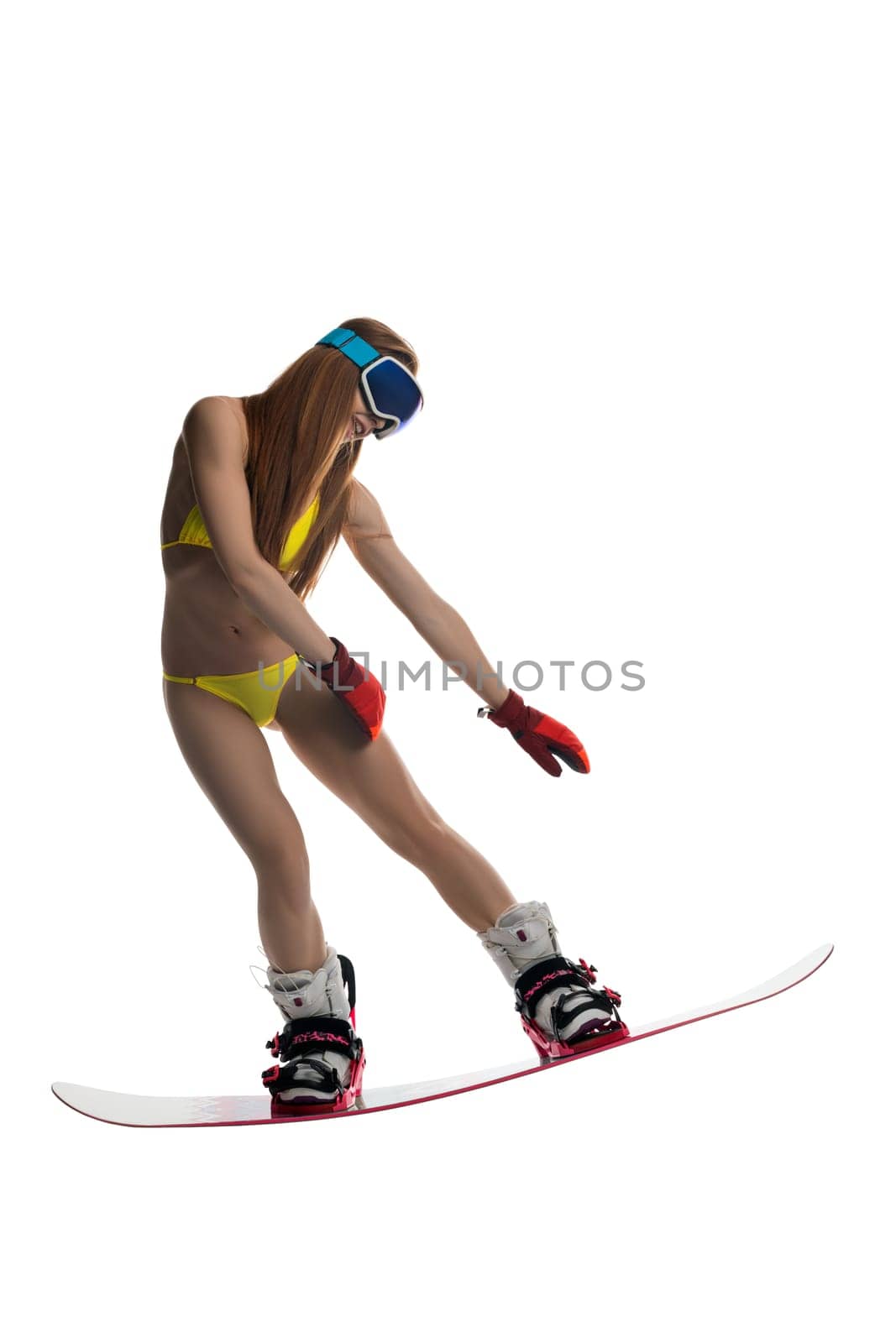 Girl in bikini, mask and gloves on snowboard isolated view