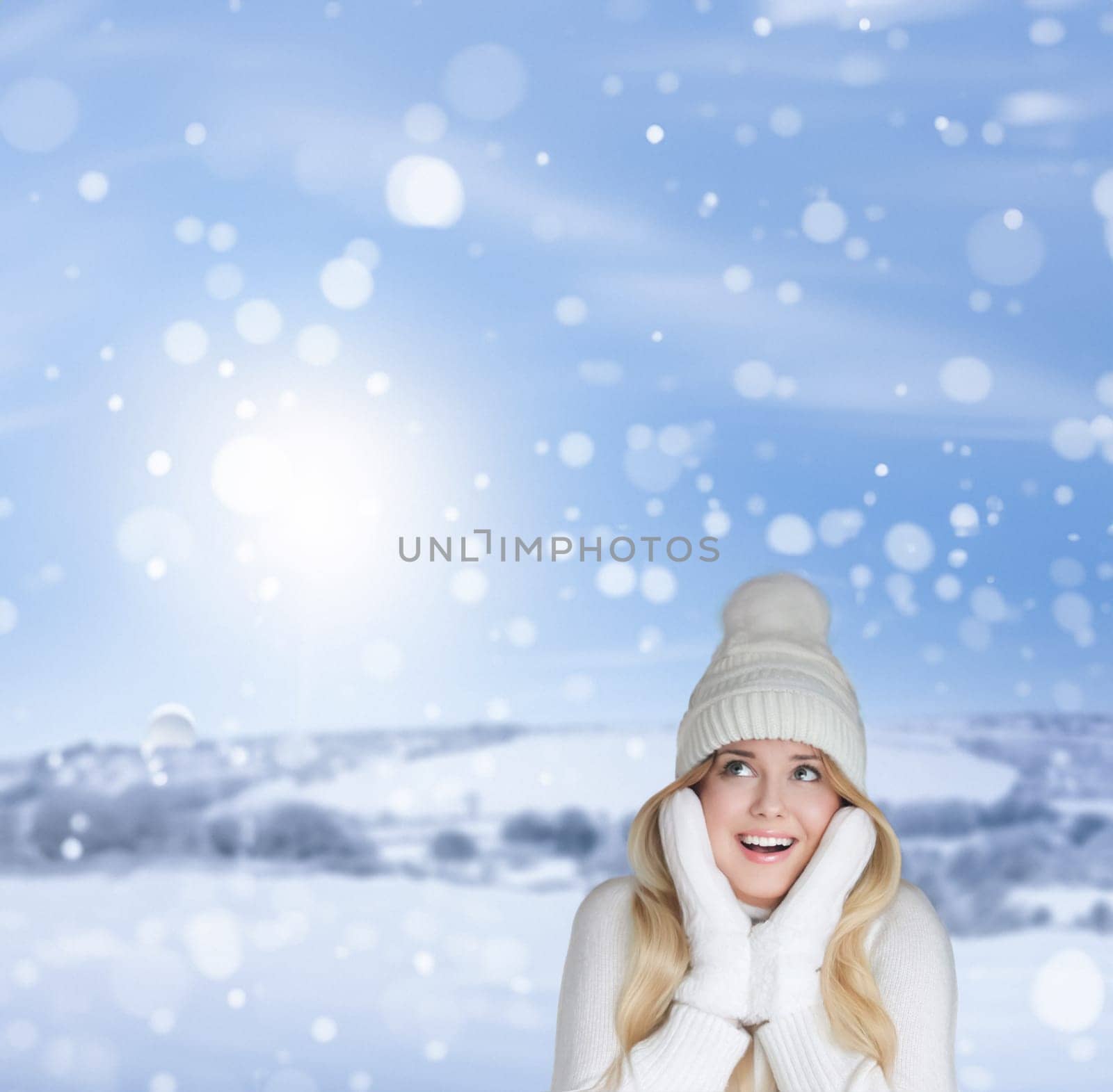 Blonde woman wearing warm mittens, knitted beanie hat and jumper, winter snow nature background with copyspace fashion and lifestyle idea