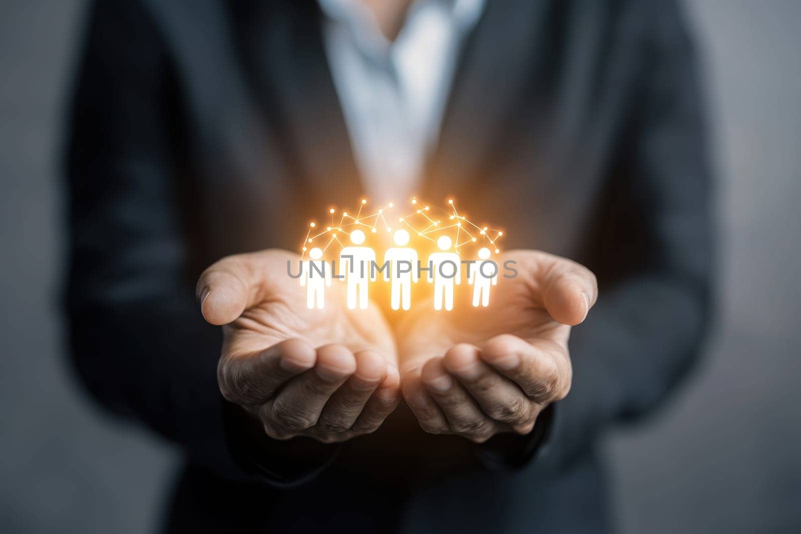 Hands hold a glowing representation of people interconnected in a digital network, symbolizing collaboration, interaction, and modern business relationships.