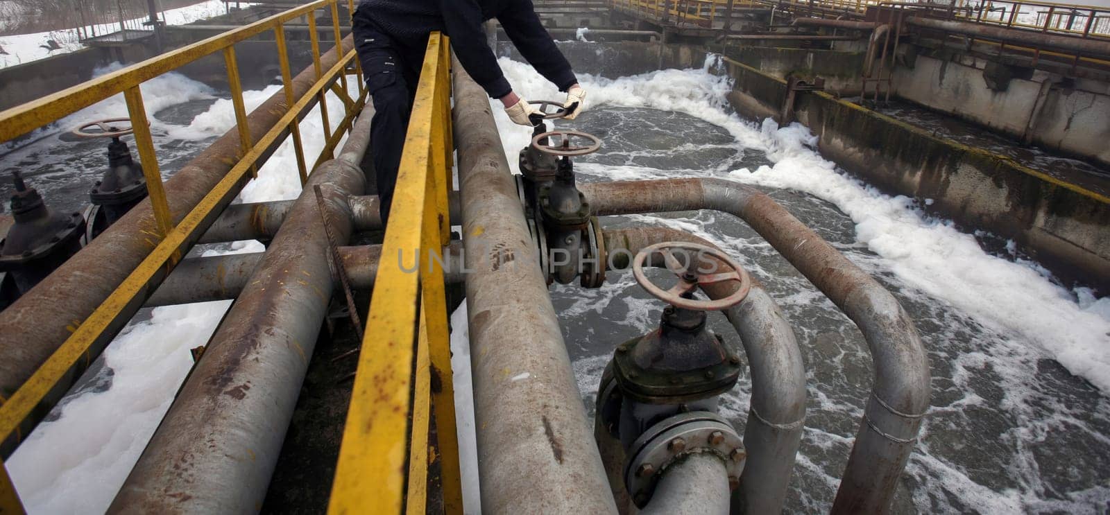 Operators monitor and adjust valves at a historic water treatment facility, ensuring proper water processing and flow management.