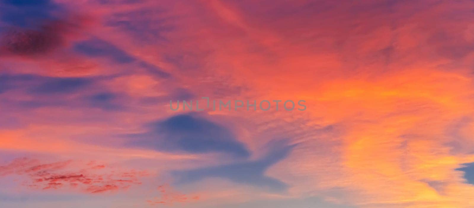 red orange clouds at sunset in a beautiful sky in the evening