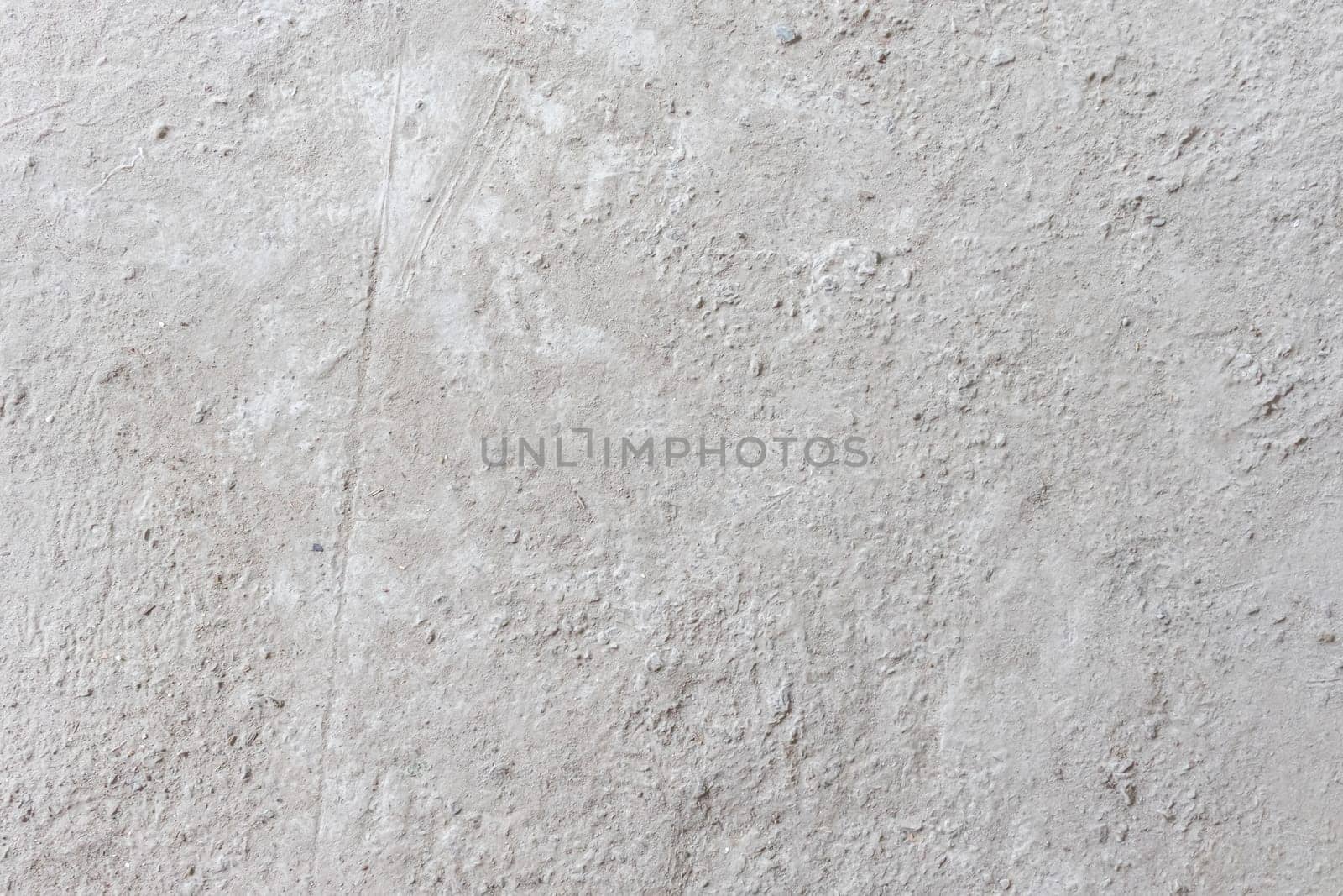 A textured white concrete surface featuring rough details and natural imperfections, suitable for minimalist and industrial-themed projects.