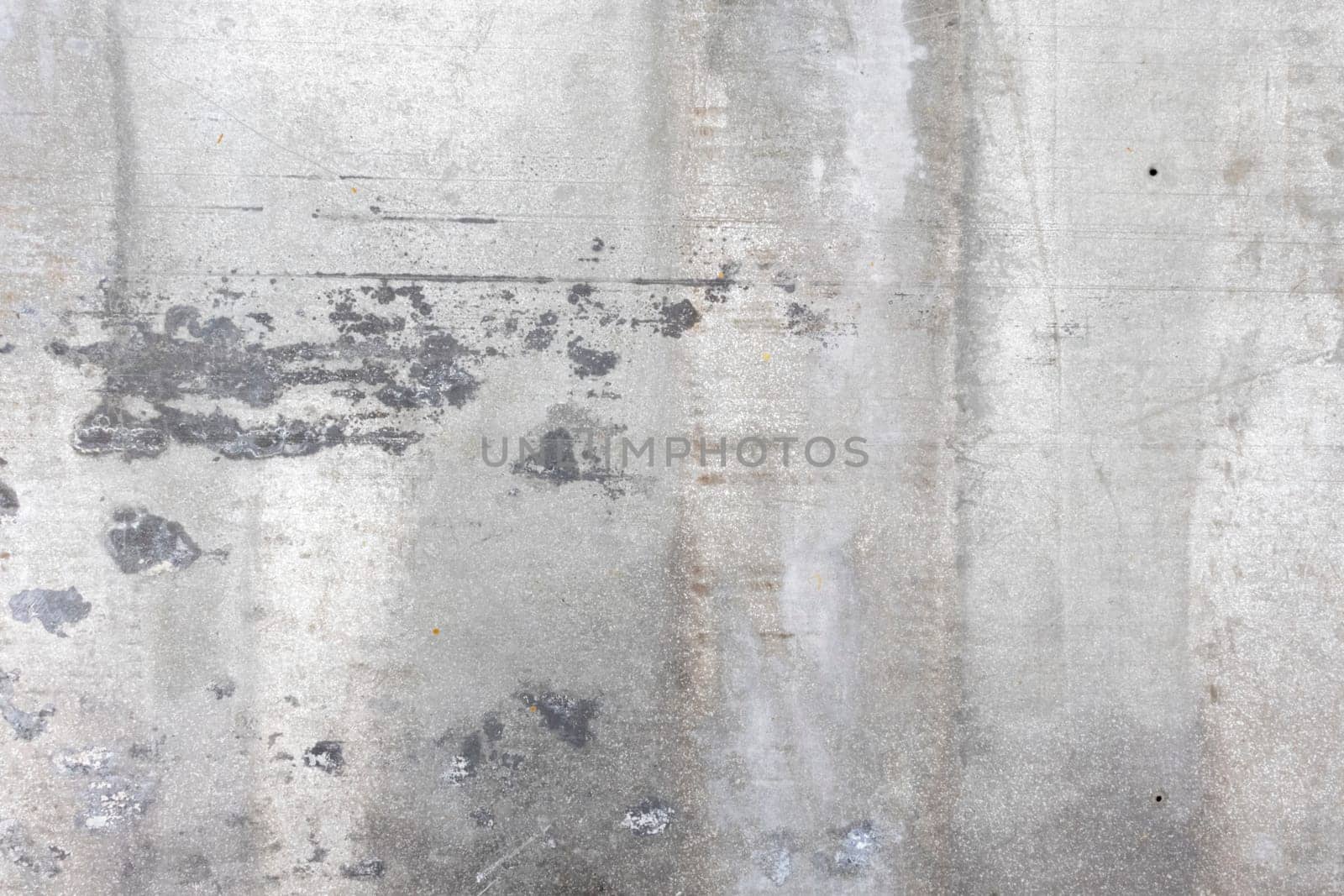 A rough-textured concrete surface showcasing weathered patterns and rugged details, suitable for industrial or rustic-inspired designs.
