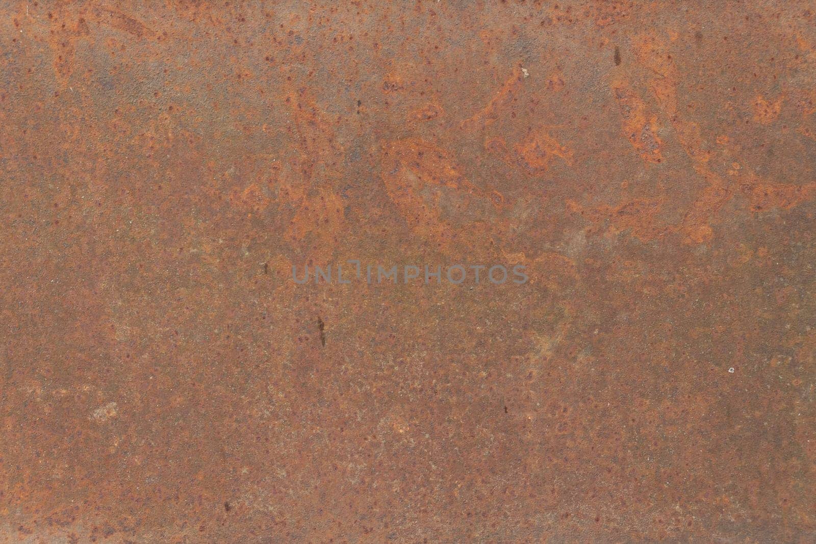 A vibrant close-up of rusted metal with rich orange and brown tones, displaying corrosion and natural patterns suitable for industrial-themed designs.