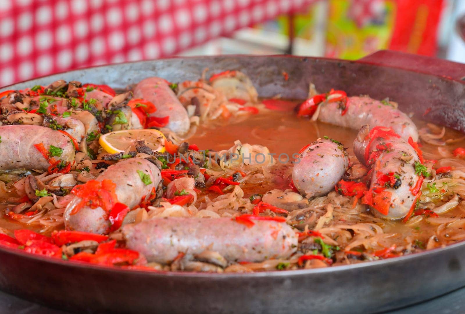 Big pan of andouillettte dish with the vegetables on a french market