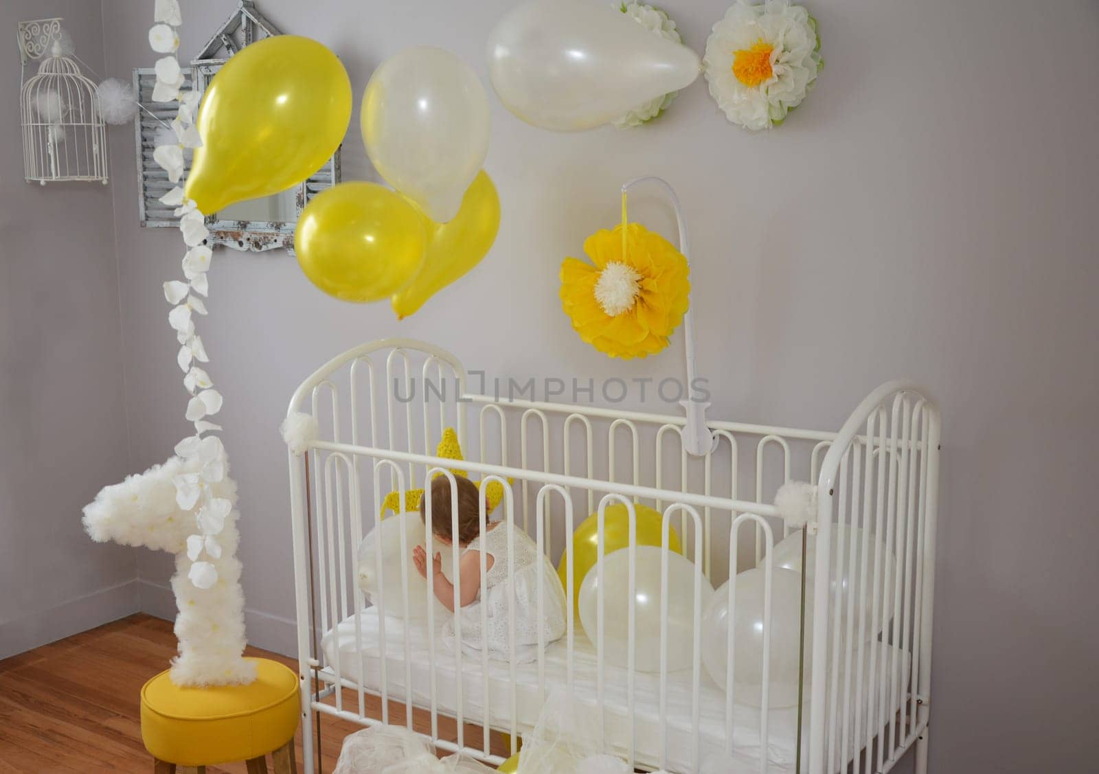 Little girl in a white dress celebrating first birthday