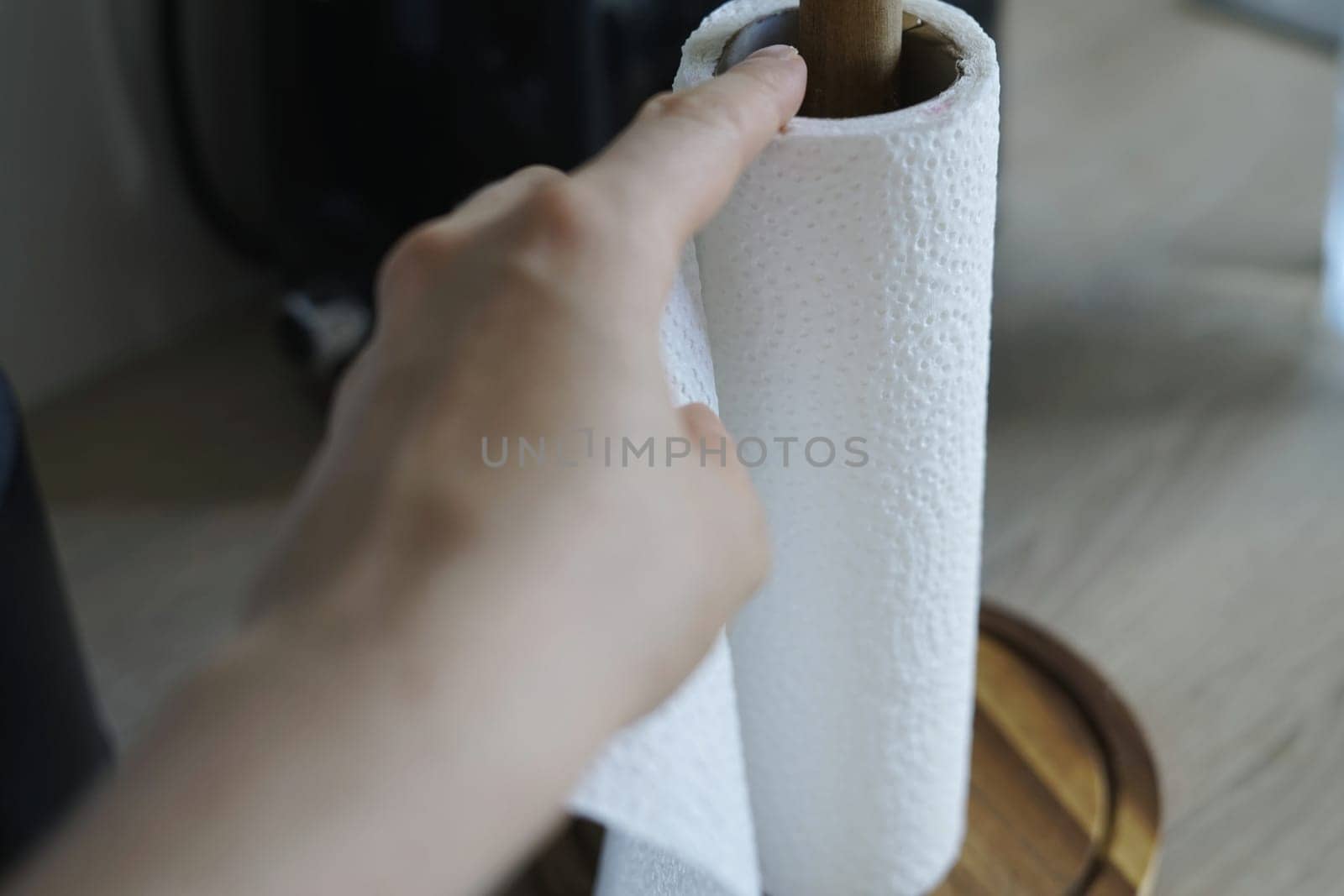 woman hand using tear off paper towel dry hands clean table surface disinfect bacteria virus ecology. High quality photo