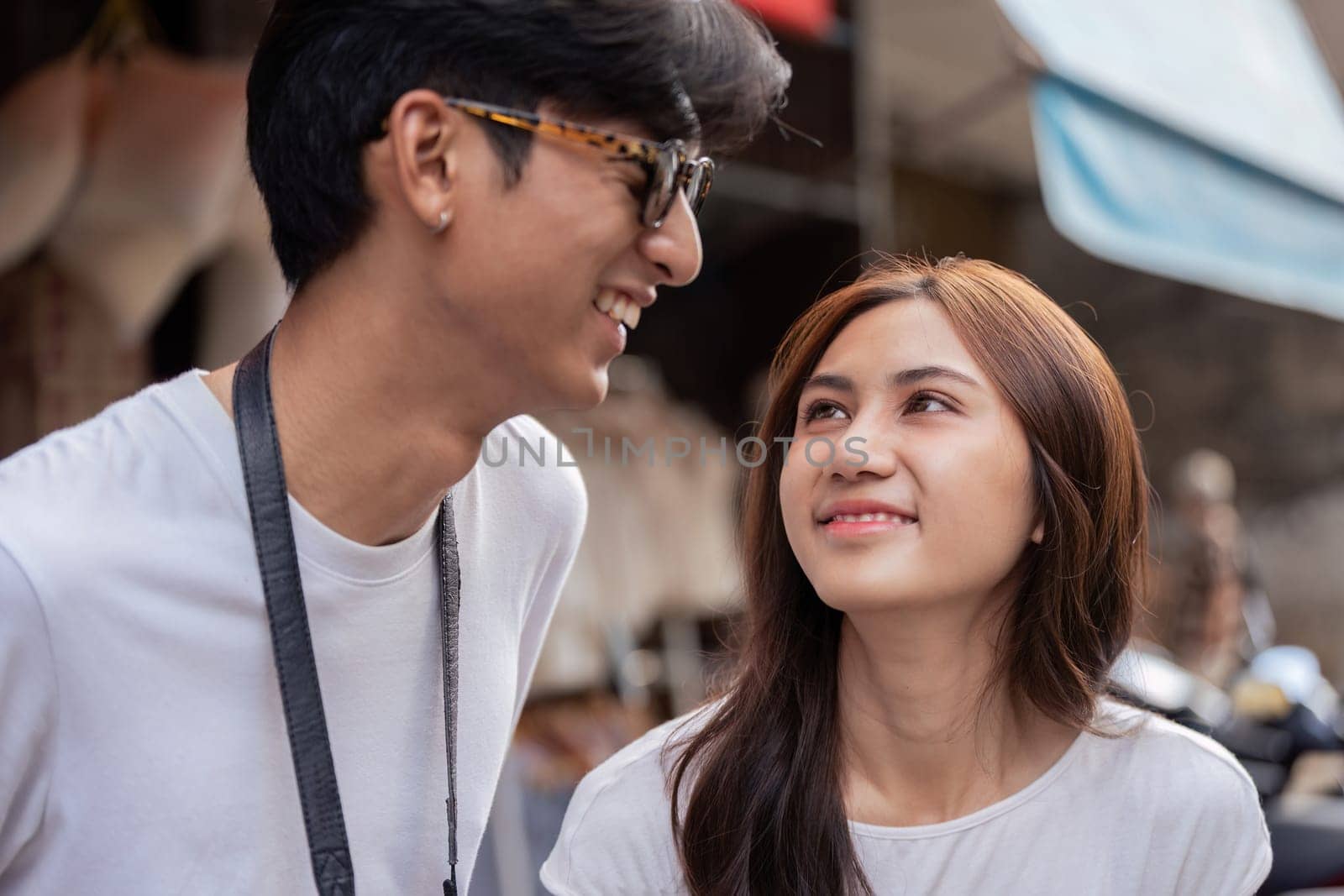 A couple shares joyful moments while traveling in a bustling market showcasing their strong bond and excitement.