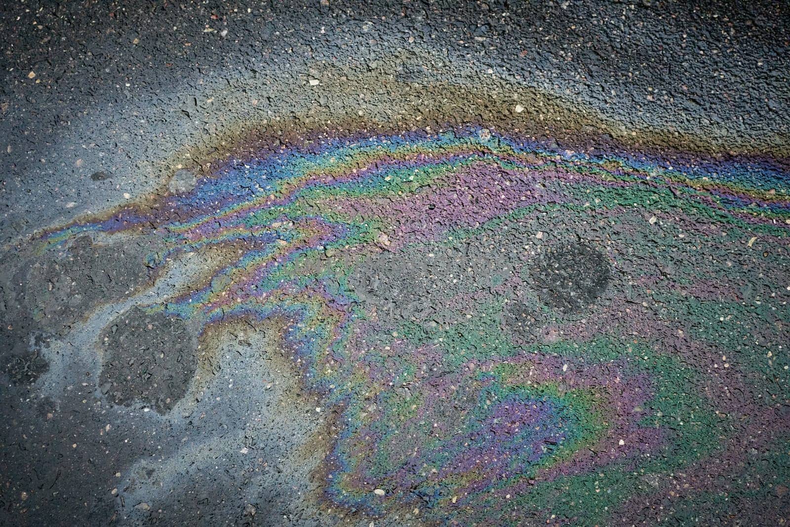 Oil and Gas Stains on the Surface of a Parking Area.