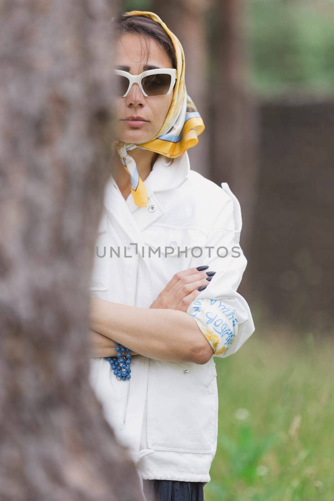 Fashion outdoor photo of beautiful young woman looking like elegant lady,wearing white jacket and accessories. Scarf trendy fashion accessory season