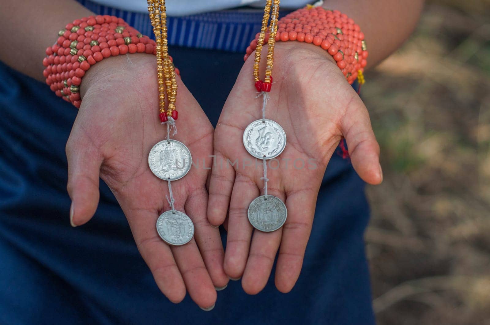 Preserving History: Indigenous Woman Displaying Ecuador's Antique Sucre Coins by Raulmartin