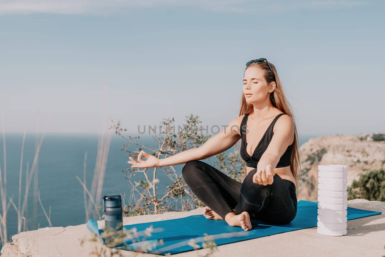 Fitness woman sea. Outdoor workout on yoga mat roller in park near to ocean beach. Female fitness pilates yoga routine concept. Healthy lifestyle. Happy fit woman exercising with rubber band in park. by panophotograph