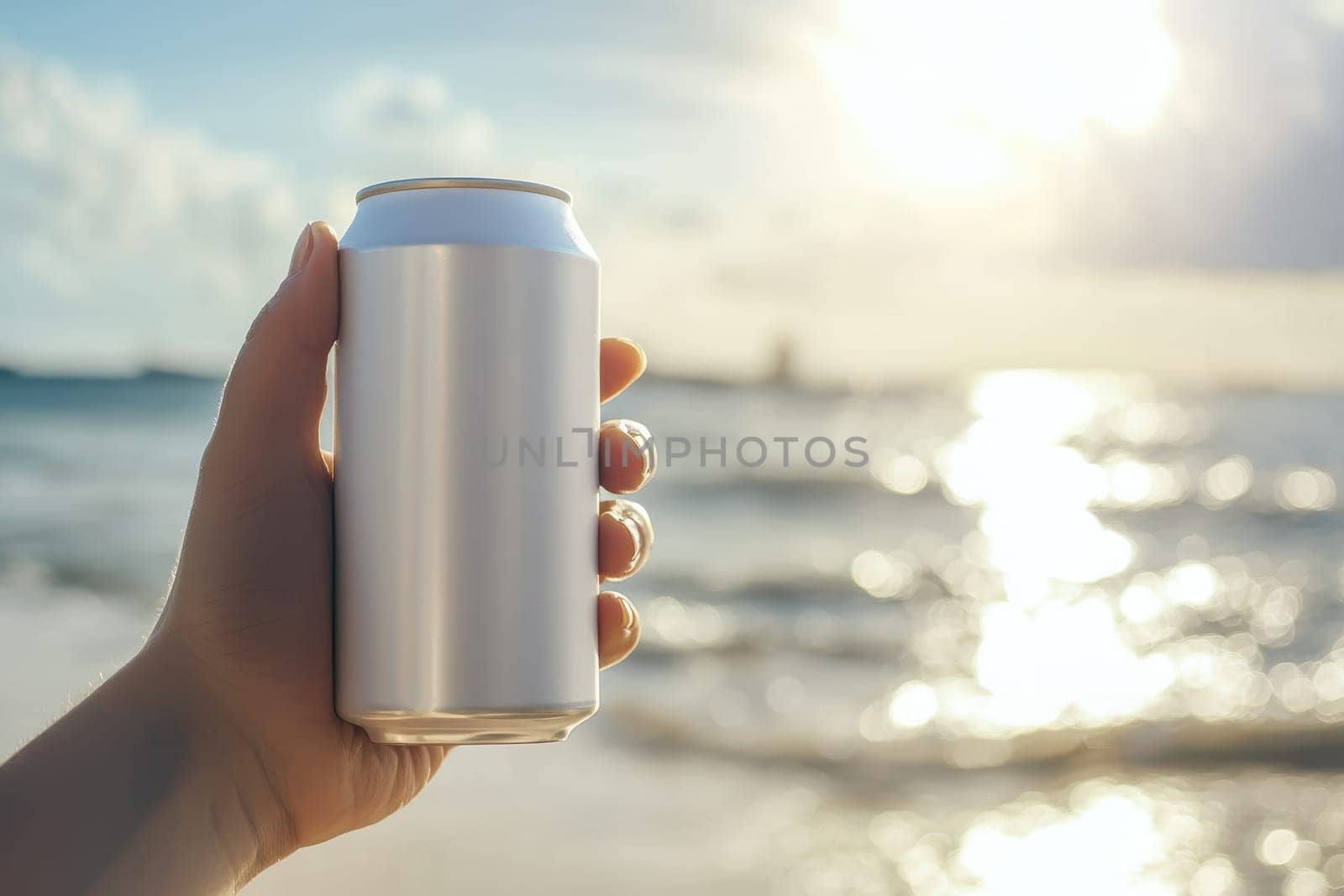 A hand holds a white soda can against a bright ocean backdrop, capturing a refreshing moment under the sunlight. Perfect for summer-themed visuals.