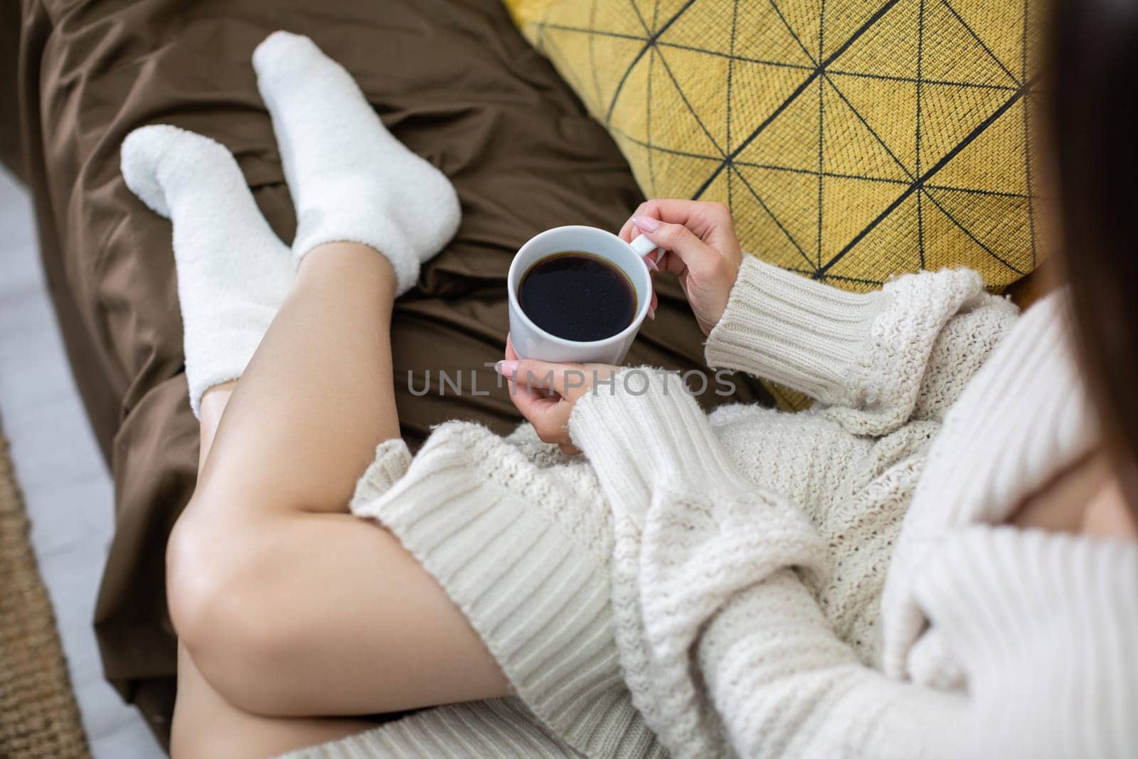 A tranquil and peaceful scene featuring a person enjoying their coffee while relaxing in comfortable, cozy attire