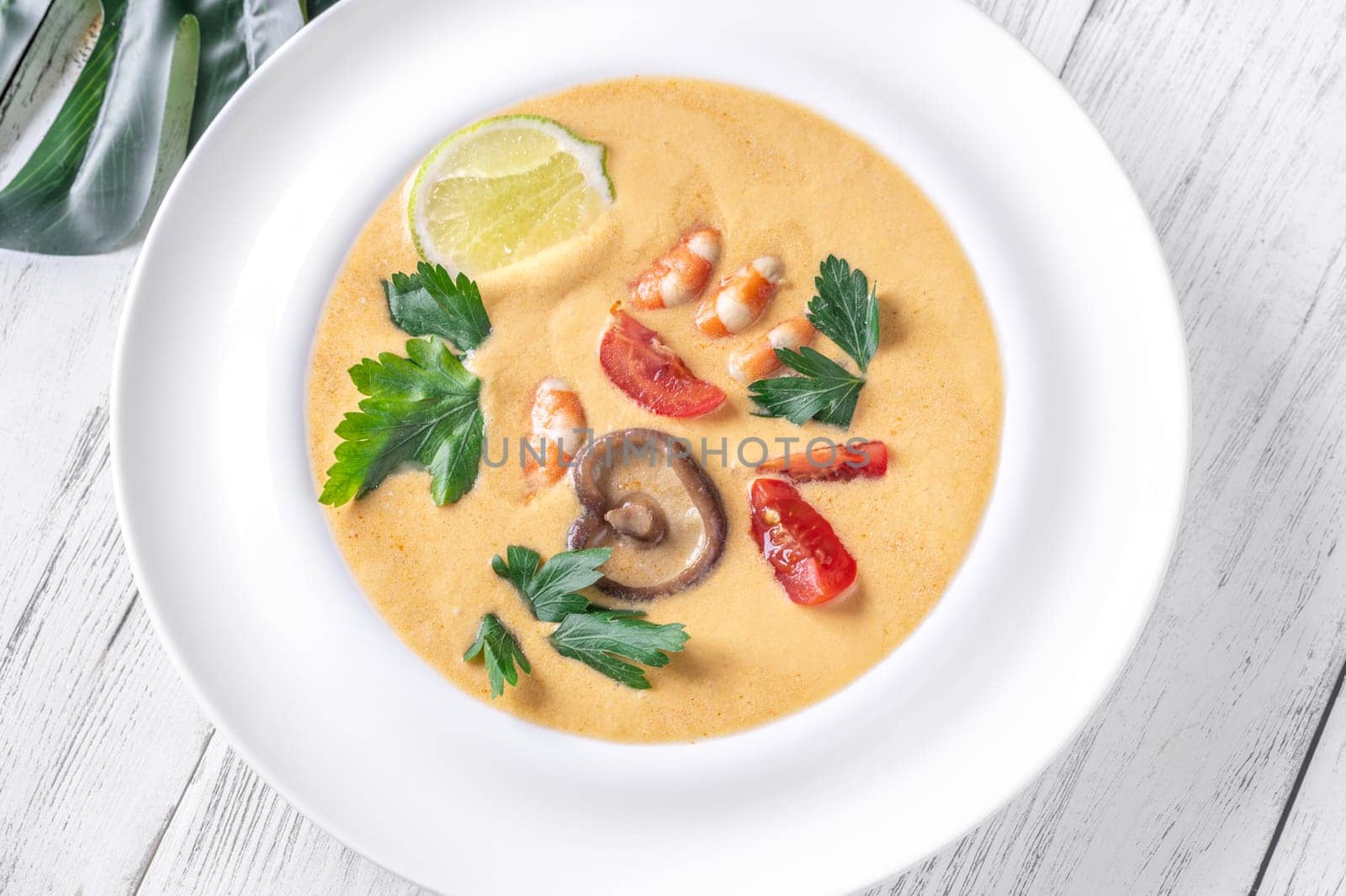 Authentic Thai Tom Yum soup with coconut milk, shrimp, and fresh herbs