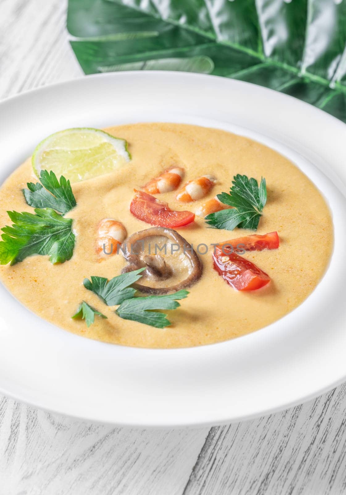 Authentic Thai Tom Yum soup with coconut milk, shrimp, and fresh herbs