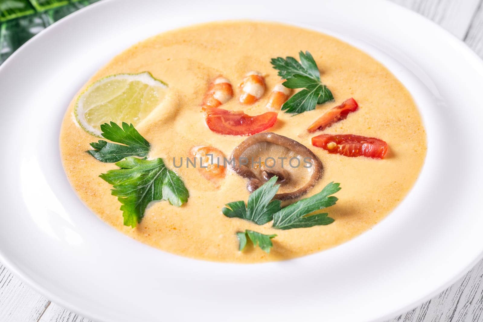 Authentic Thai Tom Yum soup with coconut milk, shrimp, and fresh herbs