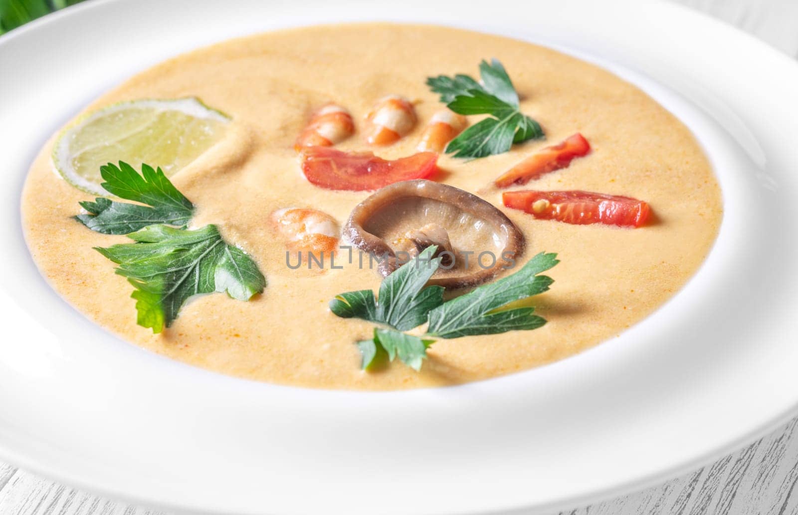 Authentic Thai Tom Yum soup with coconut milk, shrimp, and fresh herbs
