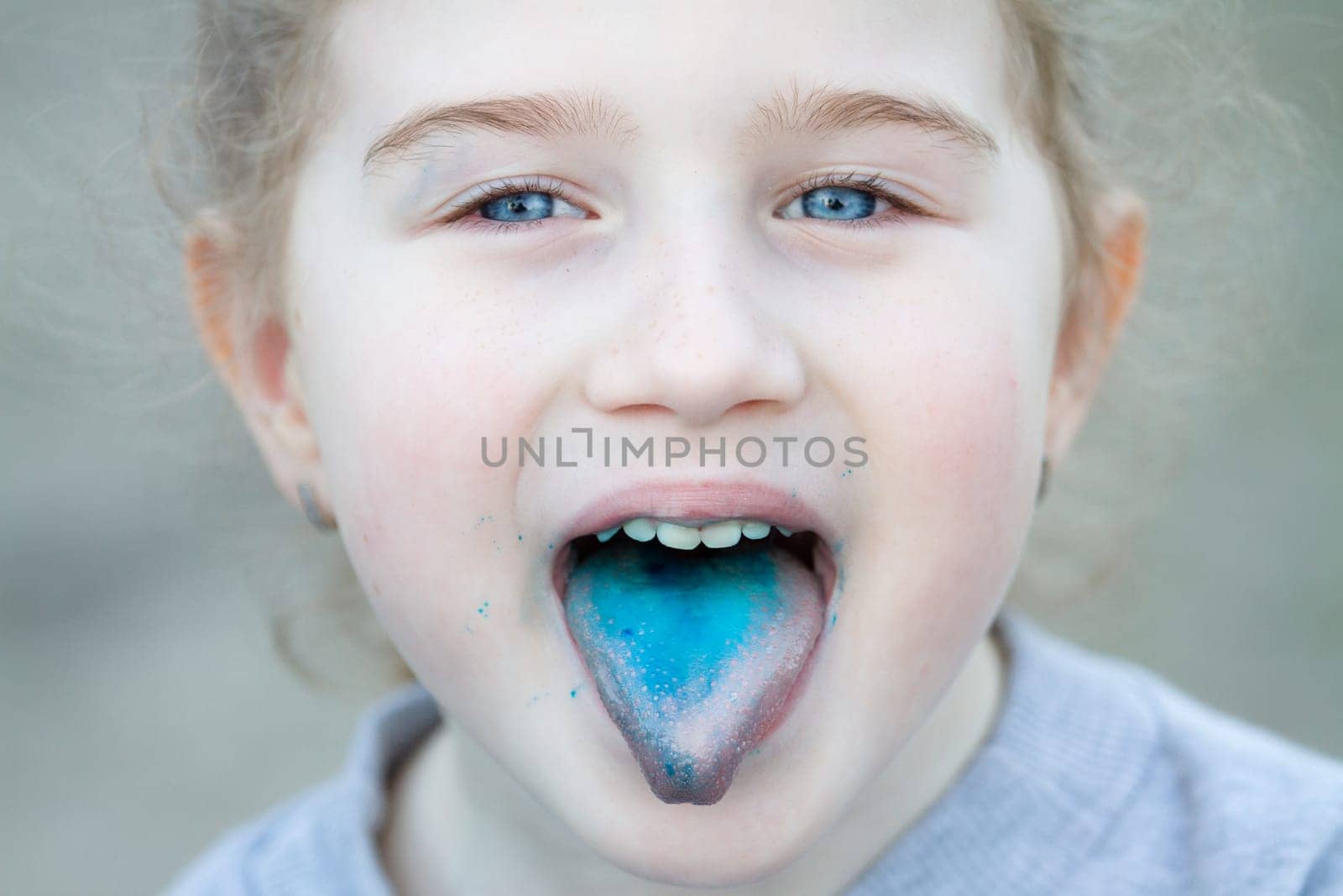 little pretty girl and blue tongue after cotton candy, people