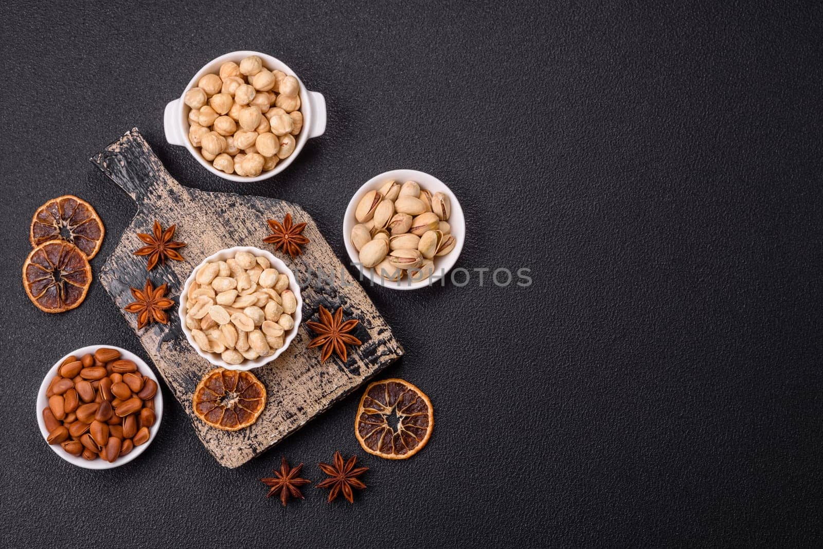Delicious nutritious peanut in ceramic bowl on dark concrete background