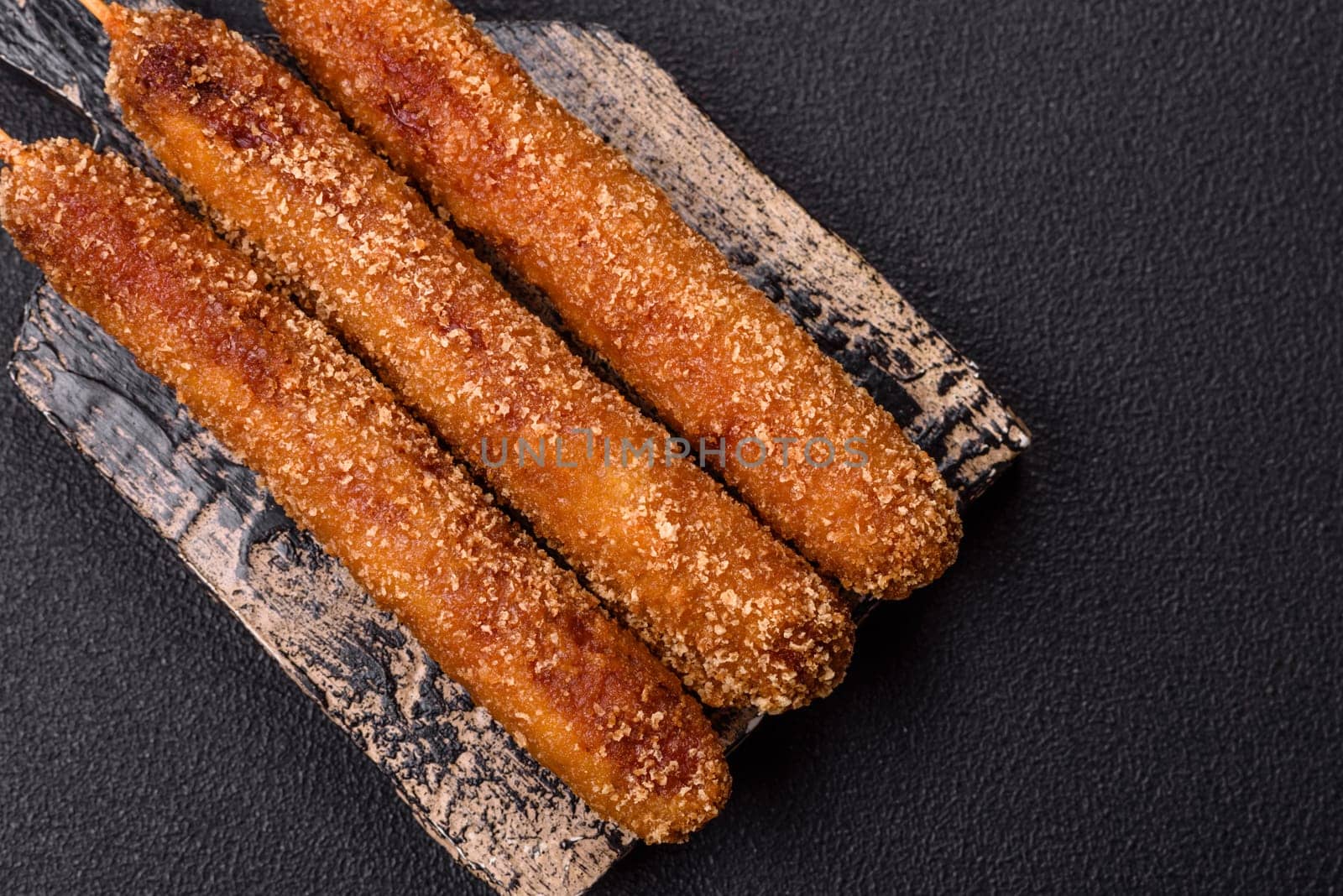 Lula kebab meat fried on a fire in breading with salt, spices and herbs on a dark concrete background