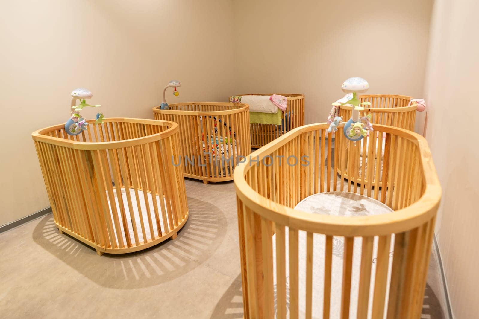 Bright and calming baby nursery with wooden cribs and neutral tones for a peaceful environment