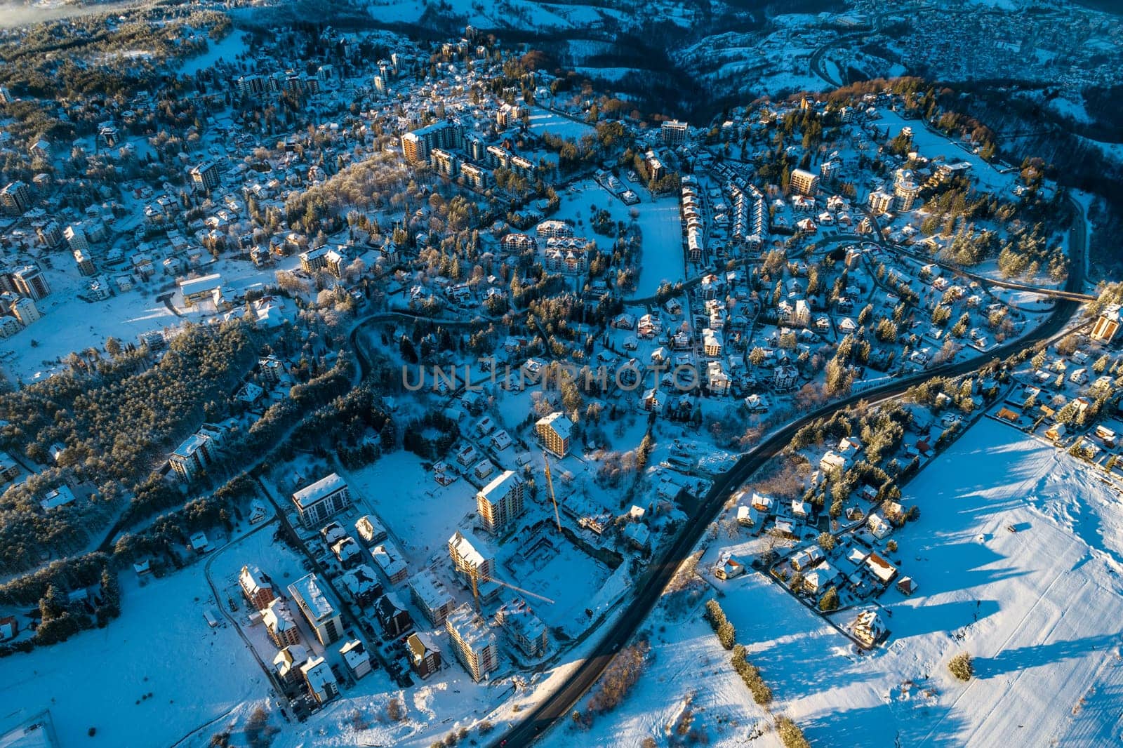 Panoramic aerial view of Zlatibor town and low cloud over Zlatibor Mountain at winter sunset, Cajetina, Serbia.