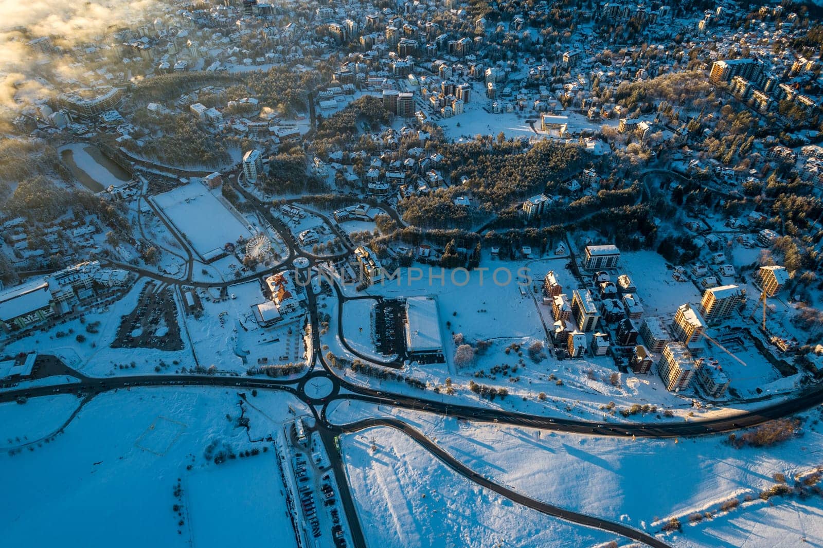 Panoramic aerial view of Zlatibor town and low cloud over Zlatibor Mountain at winter sunset, Cajetina, Serbia.